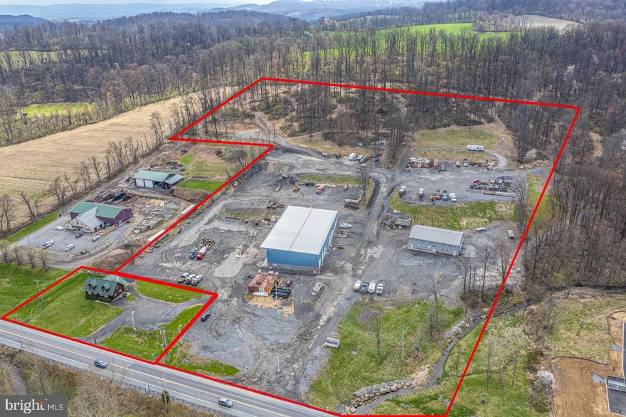 Rare opportunity to acquire an 18.6± acre Highway Business–zoned commercial complex with 623 feet of frontage along Memorial Highway (Route 73), the primary commercial corridor through Oley Township. This two-parcel offering combines a 2019-built, 15,040 SF high-bay pre-engineered metal shop with 4,256± SF additional garage space and a separate 2,904 SF professional office building for approximately 21,000 SF of modern improvements on a single integrated campus with turnkey shop, yard, and office facilities ideal for trucking, paving, construction, municipal, or heavy equipment users.

The main facility at 784 Memorial Highway features 32' clear heights, multiple drive-through truck bays, dedicated wash and paint bays, mezzanine storage, parts room, 10-ton crane service, and well-finished office/breakroom areas, designed to support fleet and heavy-equipment operations. Site infrastructure includes a complete fuel system with over 22,000 gallons of gasoline and diesel capacity, a 45,000-gallon buried water storage tank, engineered wash bay with oil separator and 3,000-gallon holding tank, on-site water and septic, and expansive stone yard for truck parking, equipment staging, and material storage.

The additional 4,256± SF garage building on the main parcel is leased to an established tenant, providing in-place income with options to renew, while the separate log cabin–style office at 792 Memorial Highway offers flexible administrative, rental, or future disposition options. Both parcels benefit from HB zoning that permits contractor shops, warehousing, trucking, and a broad mix of commercial uses without special exceptions, creating long-term flexibility and strong underlying land value in a high-visibility corridor.

Owner-users seeking immediate operational capacity will appreciate the move-in-ready condition, modern construction, independent utilities, and significant time and cost savings versus trying to replicate this setup, with replacement costs estimated in excess of current pricing guidance. This is a compelling opportunity to secure a scarce large-acreage highway-front facility in Berks County with built-in infrastructure and income.
