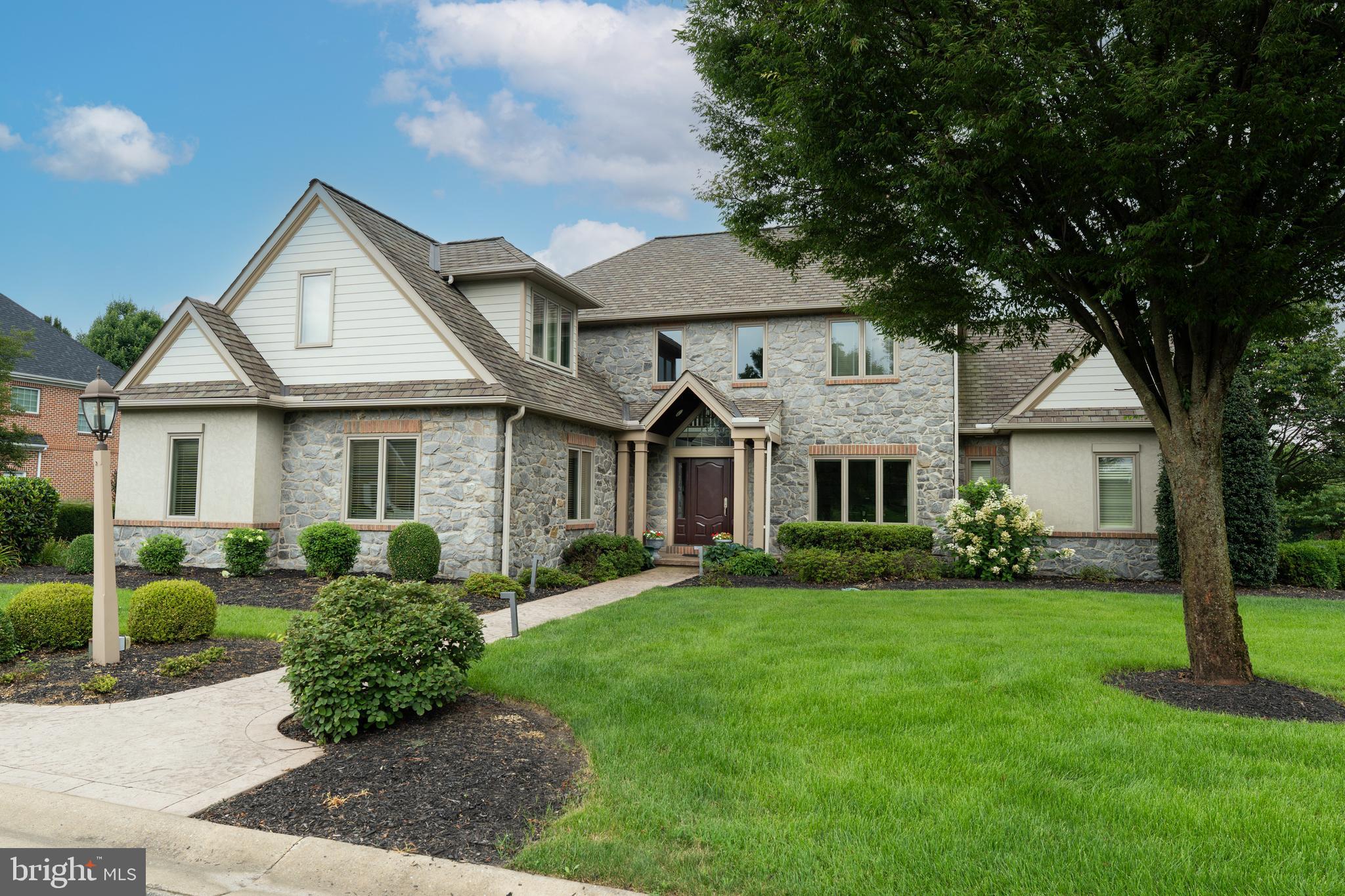 Magnificent award-winning "Parade of Homes" residence custom-built by Stiegel Construction. No detail was overlooked in the creation of this stunning home featuring five spacious bedrooms, five full baths, and two half baths. Nestled in the Bent Creek Country Club community just off the fairway of the golf course's 12th hole, the property is located within Manheim Township School District, Reidenbaugh Elementary. From the moment you enter the grand two-story foyer, adorned with marble floors and a radiant chandelier, it’s clear this is no ordinary home. Every detail speaks of luxury – gorgeous custom woodwork, marble accents, gleaming hardwood floors, and high-end appliances. The heart of the home is an exquisite eat-in kitchen featuring a large center island, marble countertops, custom cabinetry, and stainless steel appliances including a double wall oven and gas cooktop. A bright breakfast room with vaulted ceiling extends the space, leading effortlessly to the screened-in porch, back patio, and resort-like pool area with spectacular sunsets and panoramic views of the golf course that lies behind. A refined sitting room or office shares a dual-sided gas fireplace with the formal dining room, creating a warm and inviting ambiance. The dining room, complete with custom built-ins and hardwood flooring, opens seamlessly into an expansive living room boasting a wood-burning fireplace and soaring vaulted ceilings with direct access to the back patio and pool. For those who work from home, a dedicated office with private exterior access offers the ideal workspace. A full bathroom and adjacent laundry room with pet shower add everyday practicality. Yet the true gem of the first floor is the lavish main-level primary suite – a private haven including its own sitting room with easy access to the pool area. The suite also includes a two-sided fireplace, expansive walk-in closet, and a spa-like ensuite bath featuring a jetted tub, walk-in shower, and dual vanities. Upstairs, four spacious bedrooms offer walk-in closets, three with private ensuite baths. The fourth is enhanced with a cedar-lined walk-in closet. The finished lower level is equally impressive, featuring a grand rec room with wet bar, powder room, wine cellar, fully equipped fitness room with sauna, and a fabulous storage area. You’ll also appreciate a dedicated workshop with convenient outdoor access, tailored for woodworking or crafts. Completing the home is a 3-car oversized garage. With lush landscaping, the exterior is just as captivating as the interior. Designed for entertaining, built for comfort, and finished with exquisite taste – this is the lifestyle you've been waiting for. Schedule your private tour today.