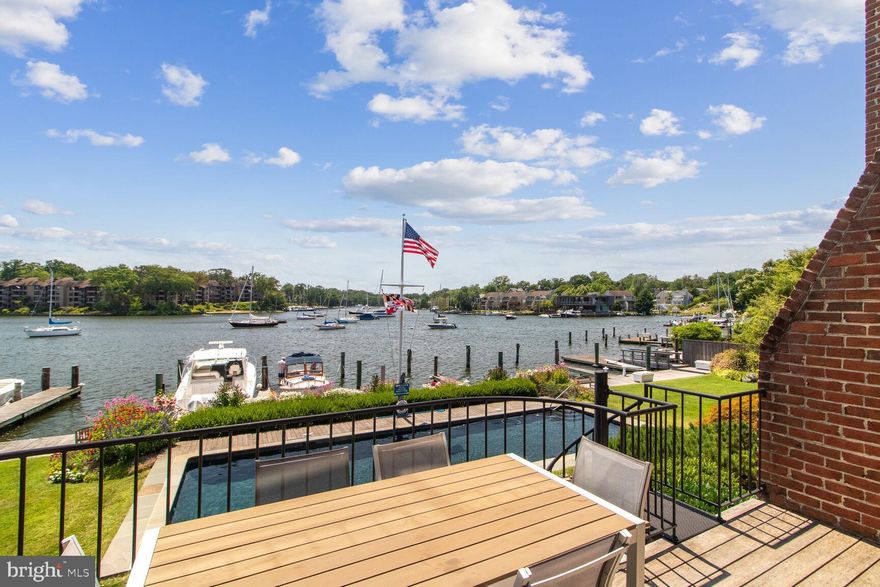 LOCATION! LOCATION! LOCATION! SPA CREEK WATERFRONT with Pool, Boat Slip and Off-street Parking! Enjoy the sophisticated total remodel of this contemporary end-unit brick duplex/townhome, at the end of Market Street in the Historic District of Annapolis. This home was gutted to the studs and totally rebuilt in 2017, so ALL NEW in 2017! The 3 gorgeous light filled levels have a fantastic front row seat on popular Spa Creek! Think of fireworks, the Blue Angels, the Christmas Lighted Boat Parade and more! The Open Plan Living Dining Combo is spacious and light-filled and the convenient nearby bar has both wine and beverage fridges.. The Living Room has generous storage closets flanking the in-set TV and gas fireplace, opens to a waterfront balcony with an electric awning and stairs to the patio below. Ebony Hardwood floors enhance the entire main level.  With 4 Bedrooms, including the built-in bunk room for 4, 3.5 splendid bathrooms, 3 gas fireplaces and generous built-ins, spaciousness abounds. There are also 9’ high Cedar Plank wood ceilings on the main level and vaulted ceilings on the upper level. The fantastic  gourmet kitchen has full height cabinets, high end appliances, glass-tiled  backsplash and a large marble-topped kitchen island with ice-maker. The home was re-designed to allow for water views through to the River,  the moment you enter the front door. The Upper Level Primary Suite is a dreamy get-away, with its large full height window providing panoramic views of Spa Creek, vaulted ceilings and a Spa-like En-suite that pampers you with its heated floor.  The Lower Level features a 4 bed Bunk Room with a spacious seating area in front of the gas fireplace. The den on this level is used as the very private 3rd bedroom and shares a Jack n Jill bath with Bedroom 4. Notice many more Architectural and Designer details as you wander throughout!
This specially detailed home is gated and has a flagstone entry courtyard with  a water fountain to greet you, rare off street parking for you and your guests, as well as the all important deeded boat slip with ice bubbler, right in front of the home. This very private 6 unit community also has the following amenities included: refreshing heated gunite pool, luscious landscaping, lawn, exterior building, pool and dock maintenance, a large floating dock and kayak racks. It’s also an easy walk to charming downtown Annapolis or catch the water taxi to town, right from your pier!
Please make plans soon to explore all this splendid home has to offer for your new easy Annapolis lifestyle!