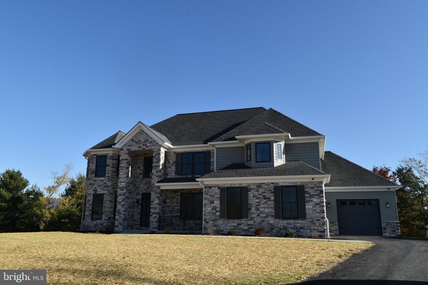 Welcome to Jasper Ridge, Hampden Townships newest community - a seven lot subdivision offering spacious lots and convenient location .  This luxurious Fred Tiday home is sure to impress as you step into the elegant foyer with recessed lighting and chandelier overhead.   The property is packed with features including hardwood flooring throughout the main floor and crown molding and recessed lighting in many rooms.  The impeccably designed kitchen boasts a large island with granite countertop, stainless steel appliances, pendant lights, as well as a large pantry for all your storage needs.  And if one kitchen is not enough, there is a generously sized second kitchen, also on the main floor!  You will want to kick back and relax in the inviting family room with exposed beams and cozy gas fireplace, or in the bright sunroom with doors leading out to a large deck.  Rounding out the main level is the large bedroom suite with walk-in closet and a door also leading out to the deck.  The generously-sized primary bedroom is located on the upper level and boasts a tray ceiling, crown molding, ceiling fan, walk-in closets, dual vanities, a soaking tub and a separate stall shower. There are an additional 3 bedrooms on this level, all with direct access to a bathroom.  Rounding out this level are a bonus room and convenient laundry room.  The large, unfinished lower level has numerous windows for plenty of natural light and doors leading out to the yard.  With rough plumbing for an additional bath in place, this area is waiting for your finishing touches.  The property boasts two separate attached garages, with plenty of extra space for storing all your equipment and outdoor toys.  
Please note that the taxes have been calculated pro forma based on the lot only.