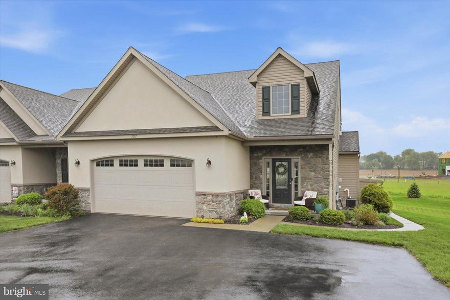 Experience upscale, maintenance-free living in this stunning custom-built luxury condo offering over 4,000 square feet of beautifully finished space in Elizabethtown. This exceptional 3-bedroom, 3.5-bath home showcases outstanding craftsmanship, thoughtful design, and high-end upgrades throughout. Features include a first-floor primary suite, private second-floor in-law suite, fully finished walk-out lower level, oversized 2-car garage, and elegant indoor-outdoor living spaces. Step through the striking glass front door into a dramatic vaulted tile foyer that opens to a warm and inviting living room with gleaming hardwood floors, recessed lighting, and a cozy fireplace. An elegant arched entryway leads into the breathtaking gourmet kitchen complete with granite countertops and island, stainless appliances, double ovens, gas range, recessed lighting, tile flooring, abundant cabinetry, and seamless flow into the spacious dining area. Just beyond, the cathedral-ceiling Florida room offers the perfect place to relax year-round and opens onto a private 10x15 composite covered deck with ceiling fan and stairs to the backyard, creating an ideal space for morning coffee or entertaining guests. The luxurious first-floor primary suite serves as a true retreat with crown molding, ceiling fan, walk-in closet, and spa-like bath featuring a whirlpool tub, oversized vanity, and walk-in tile shower with bench seating. A convenient first-floor laundry room includes a utility sink, guest toilet, and the washer and dryer are included. Upstairs, the private in-law suite offers incredible flexibility with its own full kitchen, dining area, living room with fireplace, two spacious bedrooms, and full bath. High-end finishes continue throughout with granite countertops, Wellborn cabinetry, gas cooking, crown molding, recessed lighting, custom built-ins, handcrafted bookshelves, and oversized windows that flood the space with natural light. Both bedrooms feature plush carpeting, crown molding, and ceiling fans, while an oversized storage room provides exceptional additional space. The professionally finished walk-out lower level adds approximately 1,600 square feet of living space and is ideal for multi-generational living, guests, entertaining, or a private workspace. This level includes a large office or bedroom with walk-in closet, full bath with heated tile floors and walk-in shower, spacious TV and recreation area, recessed lighting, abundant storage, and rough-ins already in place for a future full kitchen including gas, electric, plumbing, and water lines. A glass door leads directly to the backyard for easy access to outdoor living areas. Additional premium upgrades include an oversized 2-car garage with electric vehicle hookup, high-efficiency natural gas heating, water softener system, new gutter guards, extra driveway parking, upgraded faucets and toilets throughout, granite and cultured marble countertops, ceramic tile bath surrounds, and extensive storage space throughout the home. Enjoy true maintenance-free living with exterior maintenance, roofing, siding, lawn care, landscaping, and snow removal all included. Ideally located just minutes from Elizabethtown College, Mount Joy, shopping, dining, entertainment, and major highways, with convenient access to Hershey Medical Center, Lancaster, York and surrounding areas, this extraordinary home combines luxury, comfort, flexibility, and convenience in one exceptional property located within the desirable Elizabethtown Area School District.