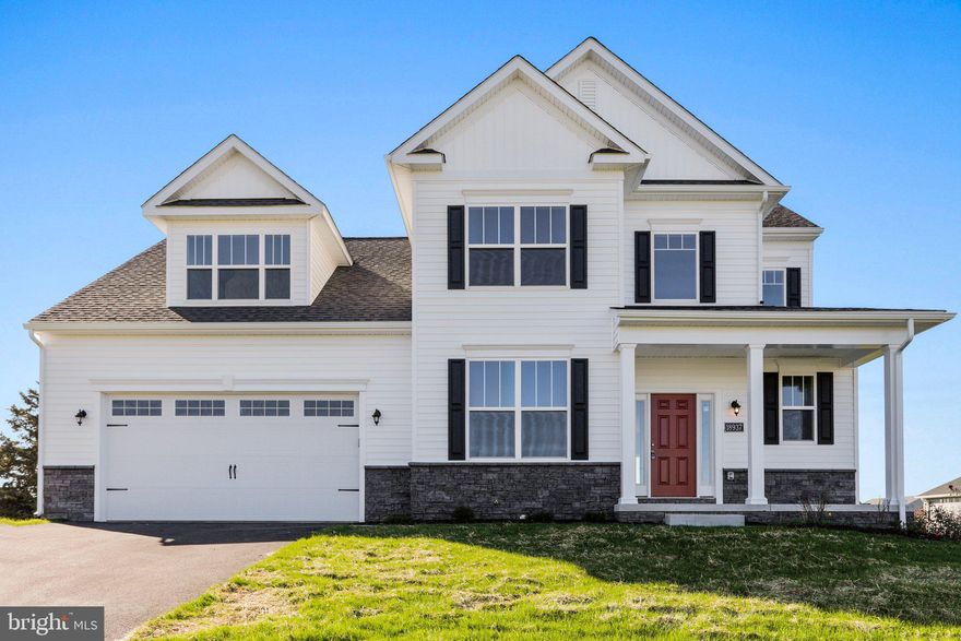 Introducing "The Anderson" at Evans Run by Manor House Builders—a beautifully designed Craftsman-style home situated on a spacious 1.81-acre corner lot in Martinsburg, WV. Currently under construction, this 5-bedroom, 3.5-bath home offers just under 3,000 sqft. of finished above-grade living space with 9’ ceilings on the main level and a layout that blends style, comfort, and functionality. Enjoy the outdoors from the welcoming front porch or take in the peaceful surroundings—this partially wooded lot offers scenic mountain views, perfect for nature lovers. Interior highlights include an expansive kitchen with stainless steel appliances, an 84" granite center island, LVP flooring throughout, a main-level owner’s suite with tray ceiling, and a cozy gas fireplace with stone surround. Thoughtful finishes like brushed nickel hardware enhance the design, while a spacious bonus fifth bedroom above the garage with its own full bath provides a private retreat for guests or multi-generational living. The walk-out basement with rough-ins offers endless potential for future expansion. Built with care and craftsmanship, and backed by a 10-year structural warranty, this home is the perfect blend of quality and tranquility—come make it yours today!