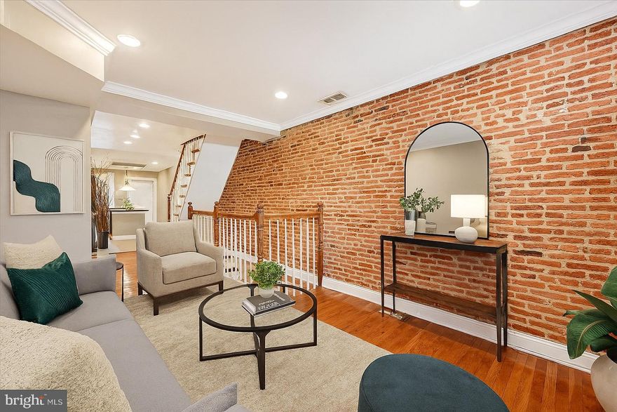 Welcome to 115 N Bradford St – a charming and stylish townhouse located just steps from Butchers Hill! This beautifully updated 2-bedroom, 3-bathroom home blends modern finishes with classic Baltimore charm, featuring hardwood floors and an exposed brick accent wall in the main-level living room. The kitchen boasts stainless steel appliances and plenty of cabinet space. Upstairs, you’ll find two spacious bedrooms, each with its own full bathroom, and access to a private balcony. The finished lower level provides additional living space, a third full bathroom, and a utility room. Enjoy outdoor living on the rear deck and the convenience of a private parking pad. All of this within walking distance to local dining, Patterson Park, and more. Schedule your showing today!