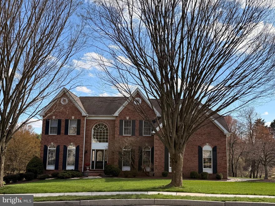 Welcome to 105 Nelson Drive, a beautifully maintained brick front colonial tucked away on one of the most coveted lots in Northampton Crest. This exceptional residence combines timeless architecture, refined living spaces, and a setting that is truly hard to replicate.
Situated on a quiet cul-de-sac with no through traffic, this home offers a level of privacy and serenity that is increasingly rare. The setting is simply spectacular—step out onto the deck and take in panoramic views in every direction. To the east, you’ll find peaceful wooded views and the reservoir; to the south, a charming pond; and to the southwest, a larger pond known for great fishing. It’s a setting that changes beautifully with the seasons and creates a true sense of retreat at home.
Inside, the home offers over 3,800 square feet of thoughtfully designed living space. A classic center hall layout welcomes you with a two-story foyer, flanked by formal living and dining rooms—perfect for both everyday living and entertaining. Hardwood floors flow through the foyer, hallway, and into the first-floor office, which features custom built-ins and provides an ideal work-from-home space.
The heart of the home is the expansive kitchen, complete with a large island, double ovens, a desk area, and a double-door pantry.  The views out the window can not be beat. The sunny breakfast area opens seamlessly to the two-story family room, where a floor-to-ceiling stone gas fireplace creates a warm and inviting focal point. A sliding door leads directly to the deck, making indoor-outdoor living effortless.
Upstairs, all four bedrooms are generously sized. The primary suite is a true retreat, entered through double doors and offering a spacious sitting area, a large walk-in closet, and a well-appointed en suite bath. One secondary bedroom features its own princess suite, while the remaining bedrooms share a hall bath.  This home has been meticulously maintained by its original owner, reflecting pride of ownership throughout.
Beyond the home itself, the lifestyle here is just as compelling. Northampton Crest is a quiet, tucked-away enclave, ideally located just above the reservoir and moments from the Churchville Nature Center. You’re also within close proximity to Northampton Township Municipal Park and Tyler State Park—perfect for walking, biking, and enjoying the outdoors. All of this, within the highly regarded Council Rock School District.
If you’ve been searching for a home that offers both refined living and a peaceful, scenic setting, 105 Nelson Drive is a rare opportunity to have both.