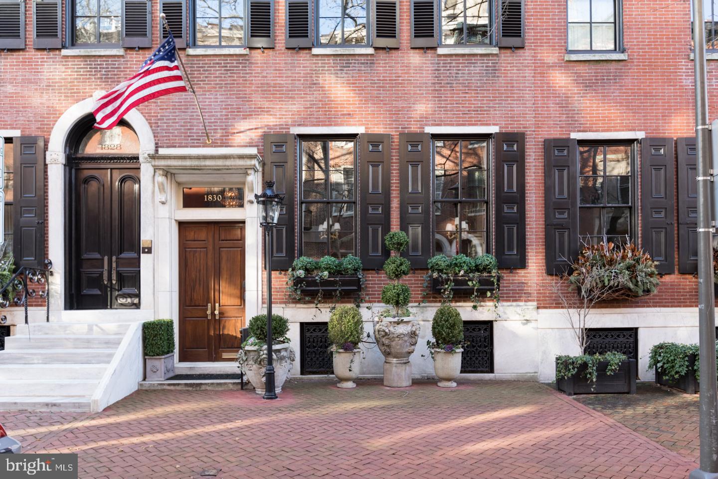 Classic Federal style Delancey Place townhome--built in the 1860s--on one of Philadelphia s most beloved blocks, only steps from Rittenhouse Square. While every inch of the home has been thoughtfully modernized, the residence also boasts restored original architectural details throughout. The brick facade of 1830 Delancey Place reaches four stories high and three windows wide (approximately 20 feet). Highlights of the home include five bedrooms, four full bathrooms and two half bathrooms, two dens, an elevator that stops on every floor, beautifully landscaped backyard patio and roof deck, eight gas fireplaces with carved ornamental mantels, exquisite plaster and millwork, and a two car tandem garage. All finishes, appointments, and details are of the finest quality and design, from the flooring, moldings, lighting, hardware, window treatments and beyond. Enter 1830 Delancey Place at street level through a pair of handsome double wood doors into a vestibule leading to the foyer. To the right of the foyer is the formal living room featuring two oversized windows looking onto Delancey Place, a wall of bookshelves and a gas fireplace. The formal dining room sits beyond the living room, connected by a small hallway with powder room, and offers a wall of built-in china cabinets, a gas fireplace and French doors that open to the back and side yard landscaped patio. The rear of the first floor houses the chef s eat-in kitchen, complete with herringbone wood floors, two tone wood cabinetry, Carrera marble countertops, a large island with seating, gas fireplace, raised breakfast nook with bookshelves and hidden coffee station, and a concealed desk area. Kitchen appliances include a paneled Sub-Zero side-by-side refrigerator/freezer, full size Sub-Zero wine refrigerator, Miele paneled dishwasher and stainless steel Dacor double wall over and gas cooktop. The striking central staircase located in the foyer leads to the second floor which has a den/library offering a wall of bookshelves, gas fireplace, and original leaded windows and plaster walls. Right outside the den is a laundry room with a Whirpool side-by-side washer and dryer and utility sink and also a wall of hidden paneled closets. The front of the second floor is comprised of the luxurious master suite. The bedroom is lined with walls of floor-to-ceiling custom closets and built-ins and also has a custom fit-out walk-in closet. The bathroom is appointed in marble and has his-and-hers vanities, an oversized shower with frameless glass door, a private commode, linen closet and fireplace. The third floor of the townhome features a wood-paneled library/den with a wood coffered ceiling, a wall of bookshelves and fireplace, as well as a powder room and wet bar in the hallway. There are also two bedroom suites, each with great closet space and full bathrooms. One of the bedrooms has a fireplace. The fourth floor offers two more bedrooms, one currently setup as a home office with walls of custom built-ins, and a full hall bathroom. It also provides access to the 425 square foot landscaped stone paver roof deck. The lower level of the home provides access to the two car tandem garage with an entrance on Panama Street, a large coat closet, mechanical room and temperature controlled wine room.