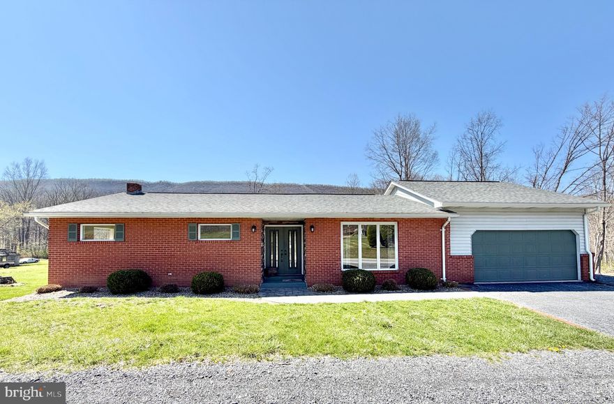 Well-maintained brick ranch home situated on 1.3 acres. The main level features three bedrooms and two bathrooms, along with a comfortable living room, dining room, and kitchen. The full basement includes a laundry area and offers abundant space for storage or future additional rooms. Step outside to relax on the rear deck, ideal for gatherings, while enjoying views of the spacious backyard and mountainside.