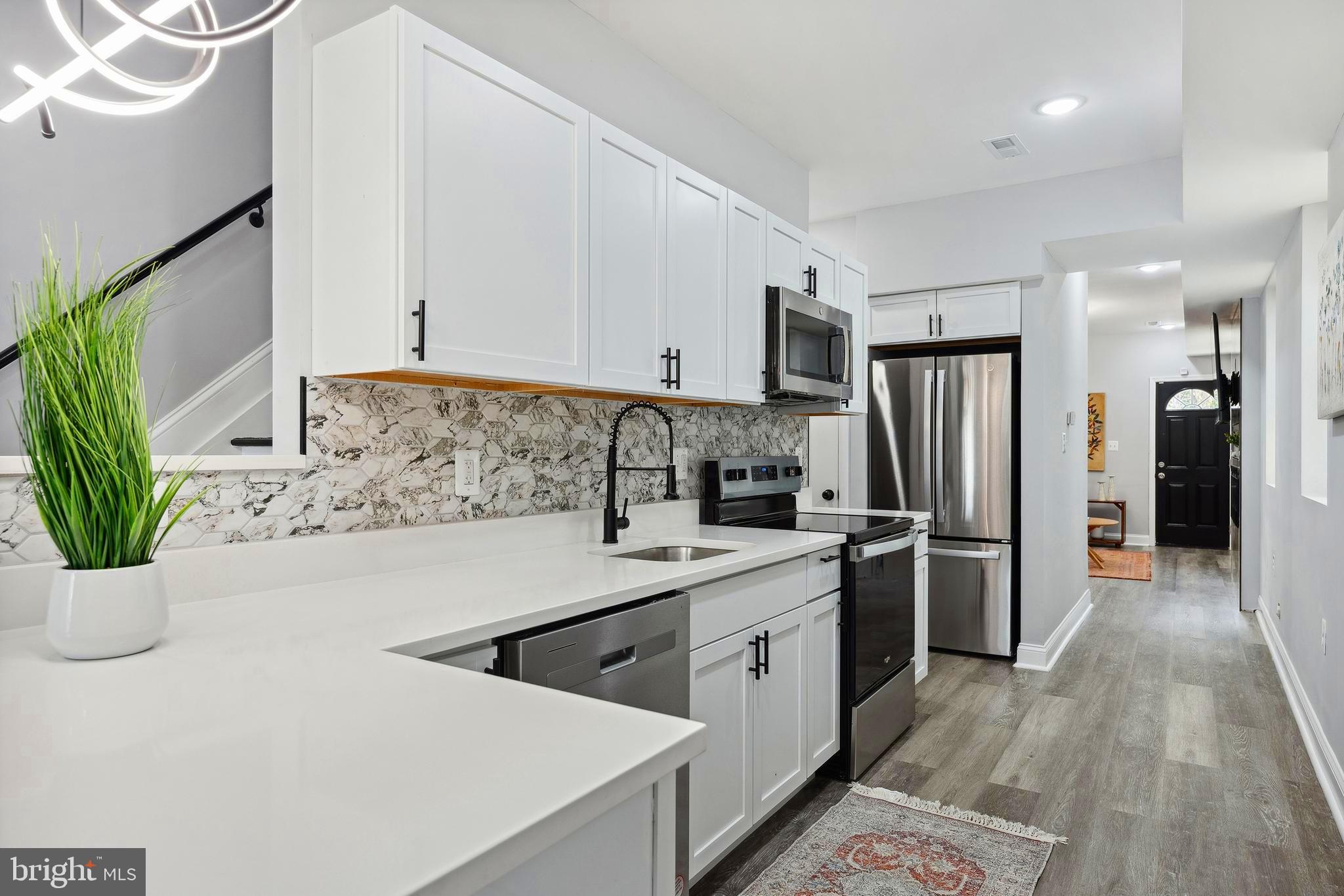 Welcome to 1223 N Central St—a fully rebuilt semi-detached home in the emerging Biddle Street corridor of East Baltimore. This modern residence blends elegant design with urban convenience in a vibrant, up-and-coming neighborhood.
Step inside to an open and inviting main level featuring a fully renovated kitchen with state-of-the-art appliances, custom cabinetry, stylish countertops, and a designer tile backsplash. The separate dining room is warmed by a cozy fireplace and includes a smart TV, creating the perfect atmosphere for intimate dinners or entertaining guests.
The spacious living room boasts a beautifully crafted fireplace mantle and a smart TV, and opens directly to the large backyard—a serene outdoor retreat ideal for relaxation and gatherings.
Upstairs, two luxurious owner’s suites offer bright, comfortable spaces with spa-style bathrooms that include multiple shower heads and modern vanities, creating private, tranquil escapes. The primary bedroom suite is enhanced by a custom fireplace mantle with built-in shelving and its own smart TV, adding both warmth and modern convenience.
This home has been completely rebuilt with attention to quality and detail, including brand-new windows, roof, heating and cooling systems, plumbing, and electrical—providing peace of mind and long-lasting comfort. The entire house is equipped with a comprehensive alarm system that will convey with the home, allowing the new owner to seamlessly take over the existing contract.
Situated in a dynamic neighborhood, 1223 N Central St offers convenient access to:
Robust transit options including bus routes and nearby MARC and Penn Station for easy commutes
Grocery stores, pharmacies, and popular eateries along the lively W Biddle St corridor
Cultural hubs such as the Station North Arts District, Fells Point, and Mount Vernon for dining, nightlife, and entertainment
Medical facilities including the University of Maryland Medical Center Midtown
Buyer Incentives & Grants Available:
Eligible buyers can benefit from Baltimore City and state programs such as the Vacants to Value Booster—a $10,000 forgivable loan for renovating vacant homes—along with Community Development Block Grants, Affordable Housing Trust Fund support, and Maryland Mortgage Program assistance.
These incentives encourage investment and revitalization within Baltimore’s vibrant neighborhoods.
Come, see, and move right in! Discover modern comfort, refined finishes, and a prime location in one of Baltimore’s most exciting redevelopment corridors.