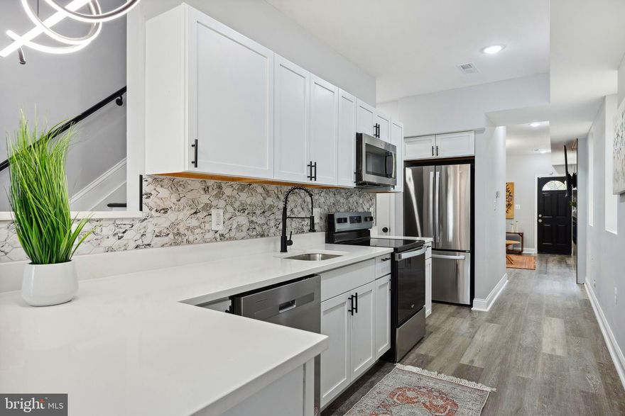 Welcome to 1223 N Central St—a fully rebuilt semi-detached home in the emerging Biddle Street corridor of East Baltimore. This modern residence blends elegant design with urban convenience in a vibrant, up-and-coming neighborhood.

Step inside to an open and inviting main level featuring a fully renovated kitchen with state-of-the-art appliances, custom cabinetry, stylish countertops, and a designer tile backsplash. The separate dining room is warmed by a cozy fireplace and includes a smart TV, creating the perfect atmosphere for intimate dinners or entertaining guests.

The spacious living room boasts a beautifully crafted fireplace mantle and a smart TV, and opens directly to the large backyard—a serene outdoor retreat ideal for relaxation and gatherings.

Upstairs, two luxurious owner’s suites offer bright, comfortable spaces with spa-style bathrooms that include multiple shower heads and modern vanities, creating private, tranquil escapes. The primary bedroom suite is enhanced by a custom fireplace mantle with built-in shelving and its own smart TV, adding both warmth and modern convenience.

This home has been completely rebuilt with attention to quality and detail, including brand-new windows, roof, heating and cooling systems, plumbing, and electrical—providing peace of mind and long-lasting comfort. The entire house is equipped with a comprehensive alarm system that will convey with the home, allowing the new owner to seamlessly take over the existing contract.

Situated in a dynamic neighborhood, 1223 N Central St offers convenient access to:

Robust transit options including bus routes and nearby MARC and Penn Station for easy commutes

Grocery stores, pharmacies, and popular eateries along the lively W Biddle St corridor

Cultural hubs such as the Station North Arts District, Fells Point, and Mount Vernon for dining, nightlife, and entertainment

Medical facilities including the University of Maryland Medical Center Midtown

Buyer Incentives & Grants Available:
Eligible buyers can benefit from Baltimore City and state programs such as the Vacants to Value Booster—a $10,000 forgivable loan for renovating vacant homes—along with Community Development Block Grants, Affordable Housing Trust Fund support, and Maryland Mortgage Program assistance.

These incentives encourage investment and revitalization within Baltimore’s vibrant neighborhoods.

Come, see, and move right in! Discover modern comfort, refined finishes, and a prime location in one of Baltimore’s most exciting redevelopment corridors.