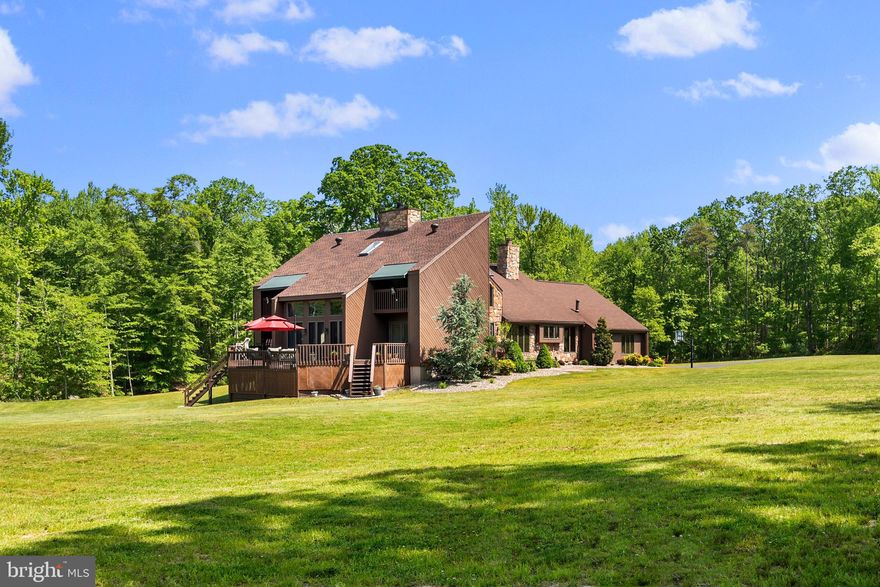 Turn-key home and COMPLETELY PRIVATE!  Just move-in and exhale...  cleared for gardening and/or livestock and bordered by mature woodlands - EXCELLENT HUNTING - ABUNDANT WILDLIFE!  This 39 acre Secluded oasis is 10 minutes from Rt. 40 and convenient to metropolitan amenities is quite the impressive locale. The property welcomes an abundance of wildlife, which is perfect for hunting, bird watching, and those who simply appreciate all nature has to offer. Enjoy scenic views from multiple outdoor decks and balconies including from from most rooms of the home. Consisting of 4,067 square feet of finished living space, this meticulously maintained residence features a LARGE MEDIA ROOM complete with WORKOUT FACILITY AND GAME ROOM! Improvements over the years include radiant floor heat, updated manifolds, new generator, renovated bathrooms, kitchen, finished basement and more! Outdoor upgrades include paved driveway, upgraded septic system, landscaping, etc. For the horse lovers out there, install additional fencing and small stable to realize that equestrian lifestyle or for niche farmers, grow organic far to table for local restaurants.