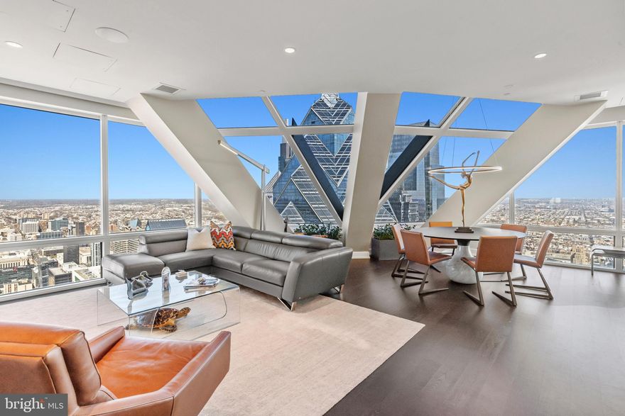 Once in lifetime opportunity to own a stunning penthouse in the sky on the 56th floor, at the pinnacle of Philadelphia’s iconic Two Liberty place.  The 56th floor, one of only four exclusive residences, was custom built with top of the line architectural design and unparalleled luxury.  This penthouse in the sky soars above the city with panoramic views of both the Schuylkill and Delaware Rivers. One Liberty skyscraper sits directly across from the primary suite, creating a headboard you have to see to believe.  Dazzling sunrises and sunsets stretch as far as the eye can see. This is Pennsylvania's second-highest residential floor, your very own observatory in the sky.
This residence showcases dramatic convex and concave floor-to-ceiling windows, nearly 11 feet tall, creating a unique sensation of floating above the city. Designed for both elegance and privacy, the expansive open-concept great room anchors the home with a statement curved glass window and gas fireplace, ideally separating the primary suite from the guest suite or private den.

The chef’s kitchen features premium Miele appliances, a Sub-Zero refrigerator, wine cooler, and sleek Italian Snaidero cabinetry, a perfect blend of modern design and function.

The primary suite is a visual work of art, wrapped in towering convex glass panels and complete with a custom dressing area and oversized walk-in closet. The spa-inspired en-suite bath is appointed in warm grey and white marble, with a soaking tub, glass-enclosed shower, and dual vanities.

The spacious second bedroom or den includes another luxurious marble bathroom and oversized closet. A marble powder room and separate laundry area are discreetly tucked away, allowing for effortless living and entertaining.

Residents of Two Liberty Place enjoy world-class amenities including 24-hour doorman and security, valet and self-parking with unlimited guest access, private storage, and direct access to the Shops at Liberty Place. The newly reimagined 37th-floor amenity level, renovated in March 2024, offers a state-of-the-art fitness center, pool, massage room, yoga studio, sauna, steam room, business center, multiple boardrooms, and an expansive entertaining lounge with breathtaking city views.  There is also a 3rd floor amenity space with breakfast to lunch served from 730am-330pm exclusively for residents and employees of the building.

This penthouse was the original developer’s model unit, showcasing the finest finishes and attention to detail, and has been impeccably maintained. Offered unfurnished, with furnishings negotiable. Luxury. Privacy. Iconic Views.  Welcome to the pinnacle of Philadelphia living.