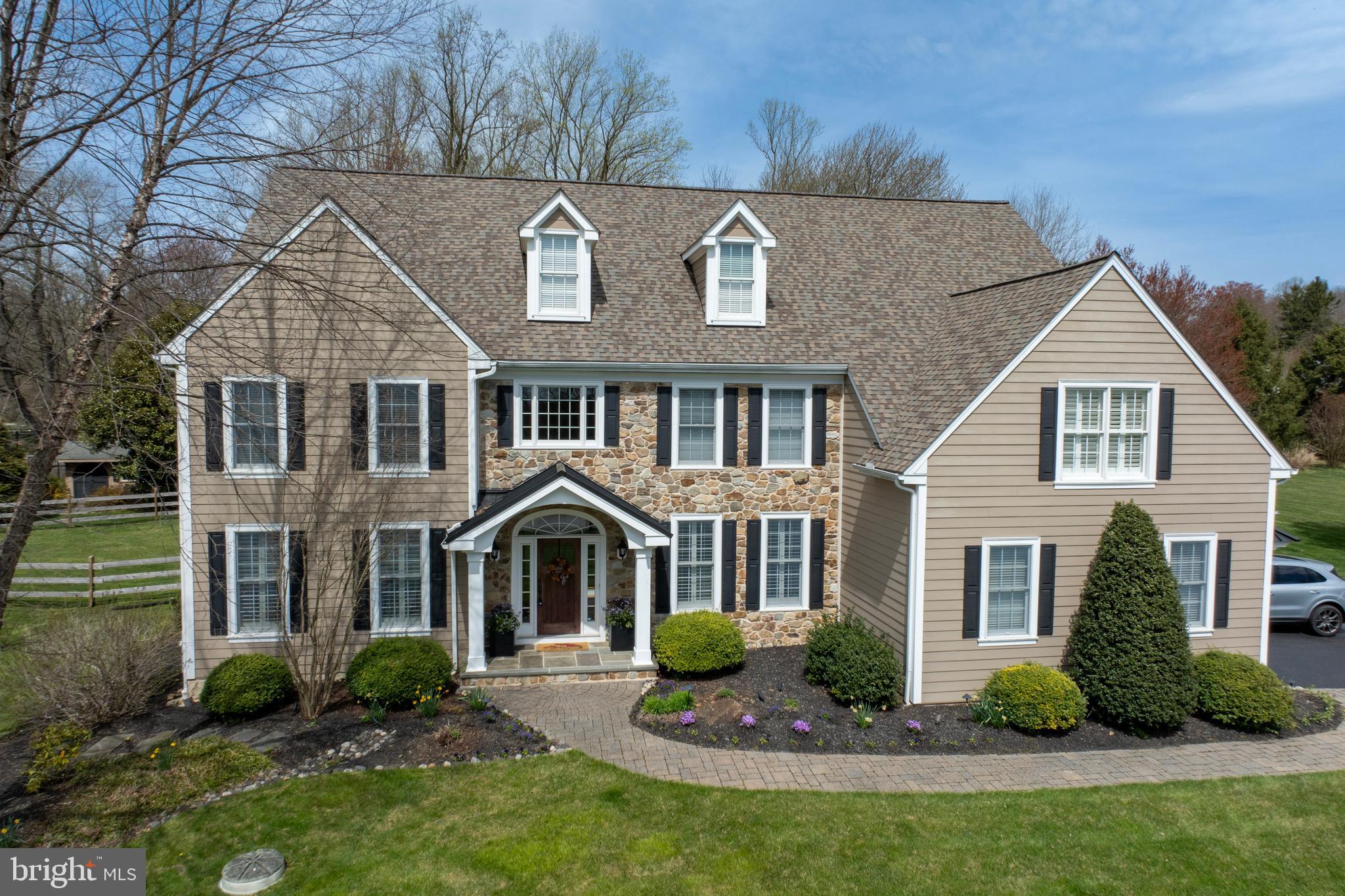 Discover an unparalleled fusion of classic Chester County grace and breathtaking contemporary design. With over $260,000 in bespoke renovations, this estate has been meticulously curated for the discerning homeowner. Situated on nearly two private acres at the end of a serene cul-de-sac, the property offers a sanctuary of tranquility and leisure, yet remains moments from the vibrant town centers of Kennett Square and West Chester.
A grand two-story foyer welcomes you, unfolding into a brilliantly reimagined floor plan. The main level is an entertainer's dream, from the formal dining room to the private study with elegant French doors. At the home's heart, the expanded great room is anchored by a commanding stone fireplace and a versatile sitting area with beautiful decorative built-in bookshelves, perfect for a library or play area.
The kitchen is a triumph of culinary design, featuring bespoke inlay cabinetry, a magnificent black walnut island, and a seamless porcelain slab backsplash with matching floating shelves. The appliance suite is second to none, with a Miele dishwasher, an 8-burner gas cooktop, and a 48” Sub Zero refrigerator. There is also a wonderful beverage center also with floating shelves. The kitchen is a true show-stopper! In addition, there is a wonderful laundry room/mudroom adjacent to the kitchen which is super convenient for coming and going from the out of doors (especially for dogs) into the fenced in area with patio and deck! There are several access points to the outside which is convenient and lends itself well to indoor outdoor entertaining!
Ascend to the owner's suite—a true private retreat. It boasts a spacious sitting room, dual walk-in closets, and a spa-like modern bath. Here, a vaulted ceiling, floor-to-ceiling porcelain tile, and an oversized dual vanity create an atmosphere of pure and tasteful luxury. There are 4 other large bedrooms with custom blinds and ample closet space as well as 2 additional full bathrooms on this floor making the morning and evening routine a breeze!
The lower level offers boundless entertainment possibilities, highlighted by a newer beautiful temperature-controlled wine cellar with cork flooring. There are two recreational areas - one with a billiard table, the other for lounging comfortably with lots of space for family and friends. There is also a full bathroom on this level for guests. French doors open to a secluded, fenced-in backyard where a beautiful stone fireplace and paver patio await, offering the perfect backdrop for memorable evenings. There is also an charming shed tucked away on the property and adjacent to a batting cage for the baseball enthusiast!
An offering of this caliber, in a wonderful location, where every detail has been perfected, is a rare opportunity.