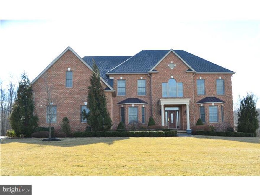 Stunning custom colonial situated on a 1.13 acre parcel in Belamour! Immaculate throughout and tastefully decorated, this home features brick on 3 sides and hardi plank on the rear, custom built with elevator to all 3 levels, geothermal heating system plus generator! Enter to a dramatic 2 story foyer with curved staircase, stunning chandelier and gorgeous hardwood flooring with custom in lays. Formal living and dining rooms with custom millwork throughout, 2 story family room with floor to ceiling brick fireplace, wet bar with cherry cabinetry and granite countertop. 1st floor study with custom built ins, screened in porch, den and gourmet kitchen with premium appliances, convenient back staircase and spacious breakfast room. Above are 4 bright and airy bedrooms including an opulent master suite with tray ceiling, sitting room, walk in closets, make up desk and luxurious bath with whirlpool tub and double shower! Bedroom 2 with private bath and Bedrooms 3 and 4 access a shared bath. Beautiful hall balcony overlooks family room. Below is a full finished walk up basement, perfect for entertaining! Media room, exercise area, game room plus full bath and plenty of storage space. Professionally landscaped gardens and 3 car side entry garage complete this beautifully built home!