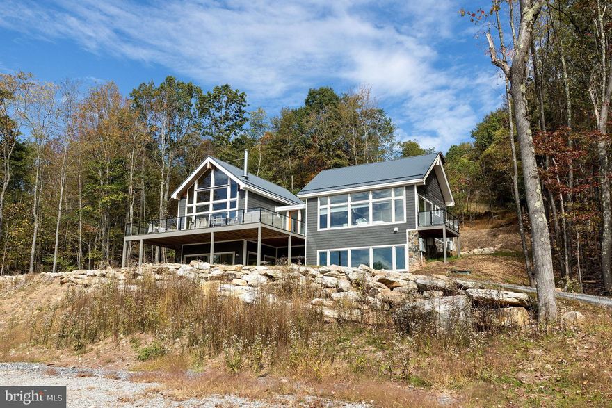 Finished in the summer of 2025, “Grey Haven” is sure to become one of the top income-producing properties in the Deep Creek Lake area! This 7-bedroom, 5-bath luxury retreat features a spacious open-concept design that blends modern comfort with timeless mountain charm. Signature amenities include a private indoor pool, an 8-foot hot tub , an expansive deck, and a custom home theater. Adding a unique character, the living room is anchored by a one-of-a-kind chandelier crafted from a locally made 1960’s canoe. Designed with sustainability in mind, Grey Haven is an exceptionally “green” home. Constructed with an ICF foundation and top-grade insulation, it uses no carbon fuels for heating or cooling. Instead, it features advanced heat pump technology, all-electric appliances, dual EV chargers, and a restored vintage Malm wood-burning fireplace—delivering eco-conscious efficiency with average utility costs under $300 per month, even with heating the pool! Additional upgrades include $10,000 in custom window treatments throughout, a full sprinkler and alarm system, and a TVRU/rental license in place, making this a true turn-key opportunity. Located just minutes from Wisp Resort, marinas, restaurants, and year-round recreation, Grey Haven is the ultimate mountain escape—whether for private enjoyment or as a high-performing vacation rental property. Call today for details!