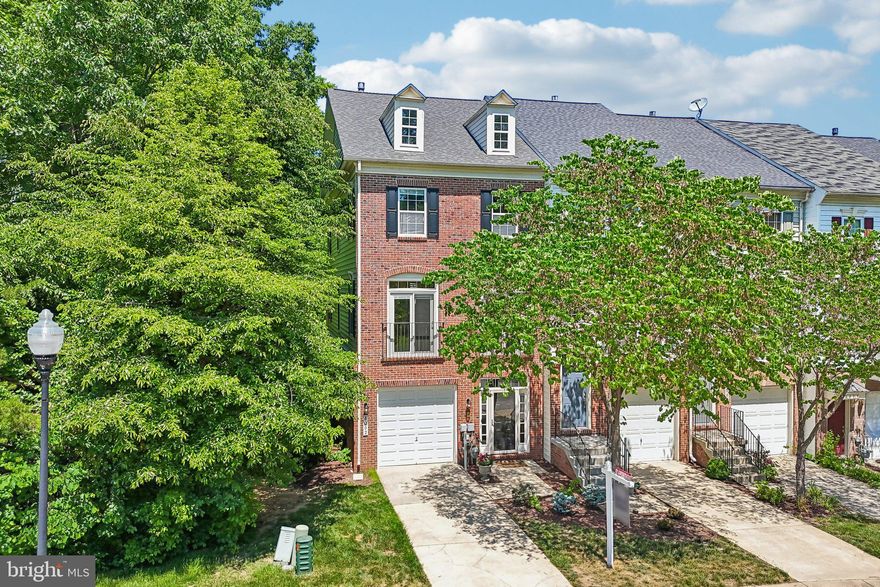 Here is the ONE you have been waiting for!  Clear your calendar, call your agent, make your appointment to see this fine home right away!  Welcome home to 8002 Pennington Drive, this brick front, end-of-group former Centex Builders model delivers exceptional architectural details, EXTENSIVE MODERN UPGRADES, and superb parking flexibility.  Enjoy the convenience of a one-car garage, a private driveway, and ample street parking for guests.  Peace of mind comes built-in with a BRAND NEW ROOF (March 2026), and a NEWER HVAC system (2021).  9-foot ceilings on all levels!  Step inside the entry-level foyer featuring classic ceramic tile, a convenient powder room, and direct access to your PRIVATE GARAGE.  This level also features a versatile recreation room finished with new luxury vinyl plank flooring (May 2026); perfect for a home office, gym, or media room.  The main living area is designed for sophisticated entertaining.  The expansive great room with BRAND NEW CARPETING (May 2026) showcases elegant double crown molding, chair rail woodwork, and a stunning THREE-SIDED GAS FIREPLACE that anchors the space.  A chef-inspired modern kitchen boasts gleaming hardwood floors, durable Corian countertops, premium stainless-steel appliances, a center island with a breakfast bar, and recessed lighting.  The adjoining dining area features custom built-in shelving and opens to a large rear deck, ideal for outdoor dining, relaxation, and star-gazing.  Retreat upstairs to the luxurious primary bedroom suite, complete with a dramatic tray ceiling, ceiling fan, recessed lighting, and a large walk-in closet.  The spa-like primary bath features dual sinks, ceramic tile flooring, and a JET-SOAKING TUB.  Two additional bedrooms equipped with ceiling fans share the hall full bath.  The laundry closet is on the bedroom level too!  The rewards of owning this home extend well beyond the front door, thanks to a very active homeowners’ association offering an impressive array of amenities.  Residents enjoy multiple swimming pools, tennis and pickleball courts, bike, jog, and walking paths, volleyball and basketball courts, picnic areas, tot lots, and more.  The HIGHLY REGARDED and tremendously desirable Russett community is strategically located between Baltimore and Washington, DC, providing exceptional convenience for work, travel, and everyday living.  Just minutes from Fort Meade, NSA, and APL, as well as major commuter routes, the Laurel MARC–Camden Line train station, shopping centers, restaurants, historic Laurel, and BWI Airport, this location truly has it all.  Everything you need is right here waiting for you-come see it for yourself and make this wonderful home your own.  All information deemed accurate but not guaranteed.