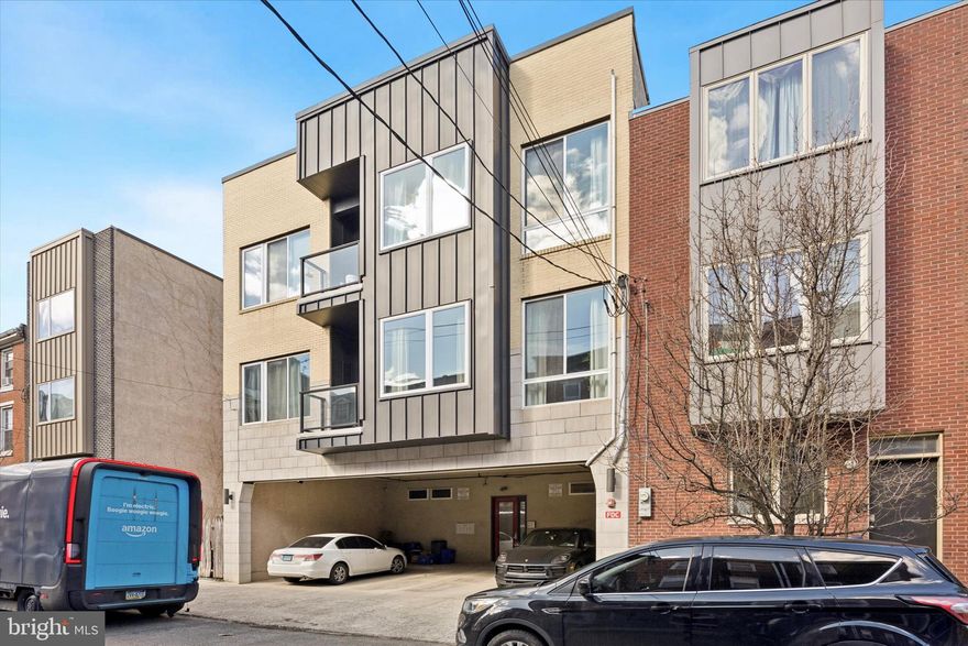 Welcome to your city escape in the heart of the vibrant Spring Arts neighborhood! This stunning 2-bedroom, 2.5-bathroom modern condo offers the perfect blend of style, comfort, and convenience, complete with a rooftop retreat boasting 360-degree panoramic views of the Philadelphia skyline. Whether you’re hosting friends and family under glowing string lights or unwinding with a glass of wine, this rooftop is a showstopper. Inside, beautiful wood floors, soaring ceilings, and expansive floor-to-ceiling windows bathe the open-concept living space in natural light. The sleek kitchen is a dream featuring dark shaker cabinets, quartz countertops, tile backsplash, stainless steel appliances, gas cooking, and an oversized island with seating for four—ideal for casual meals or entertaining guests. A pantry adds extra storage, ensuring everything has its place. Wrapping up this floor is a half bathroom for added convenience. Upstairs, two spacious bedrooms each offer private en-suite bathrooms and walk-in closets. The primary suite is a true sanctuary with a private balcony for morning coffee or a peaceful retreat, while the spa-like bath boasts a glass-enclosed shower for an added touch of luxury. Additional highlights include one covered parking space and a prime location that places you within blocks of Trader Joe’s, top-rated restaurants, and The Met Philadelphia. The Broad Street Line is just a 5-minute walk away, providing easy access to Center City, the Art Museum, Brewerytown, and major highways (I-95 & I-676). Can you picture yourself living here? Stop by for a visit and see your new home in person!