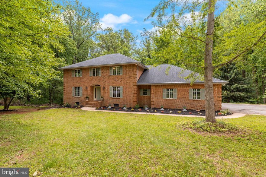 Welcome to this exceptional all brick colonial home located in the beautiful community of Kingsville. Nestled on a quiet, tree-lined lot, this property offers a peaceful retreat backing up to the Gunpowder Falls State Park. The driveway leads you to a spacious three-car garage with ample additional parking, perfect for guests or a growing household. As you step inside, you're greeted by a warm and welcoming atmosphere, enhanced by brand-new carpeting and fresh paint throughout the home. The main level is filled with natural light streaming through large Anderson windows, offering tranquil views of the surrounding greenery and seamlessly blending the indoors with the beautiful natural setting. The thoughtful floor plan includes multiple living areas designed for both comfort and functionality. The inviting family room features a classic brick fireplace—a perfect focal point for cozy gatherings—and multiple sliding glass doors that open directly to the backyard, creating a smooth transition to outdoor living. Whether you're entertaining or enjoying a quiet night at home, this space offers comfort and charm year-round. The kitchen boasts abundant cabinetry, granite countertops, a dual sink, and a sunny breakfast nook framed by bay windows that overlook the backyard. Just off the kitchen, the formal dining room provides a sophisticated space for hosting dinner parties and holiday meals, featuring rich hardwood flooring, chair rail and crown molding with plenty of room for a large dining set. Additional features on the main level include a convenient powder room and a dedicated laundry room with storage and utility space—ideal for keeping daily tasks efficient and out of sight.
Upstairs, you'll find five bedrooms, each filled with natural light and offering flexibility for guest rooms, home offices, or creative spaces. The expansive primary suite, complete with a large en-suite bathroom that could easily accommodate a luxurious redesign and walk-in closets. The second full bathroom upstairs includes dual sinks, making morning routines easier for everyone.
The lower level features an unfinished basement with high ceilings and a rough-in for an additional bathroom, offering an incredible opportunity to design the space of your dreams—whether that’s a media room, home gym, playroom, or in-law suite.

Located just minutes from Gunpowder Falls State Park, this home is a nature lover’s dream with endless hiking, biking, and outdoor recreation opportunities nearby. Despite the peaceful surroundings, you’re also conveniently close to commuter routes, major highways, shopping and dining. This Kingsville gem combines spacious living, thoughtful design, and an unbeatable location—don’t miss your chance to make it your own.