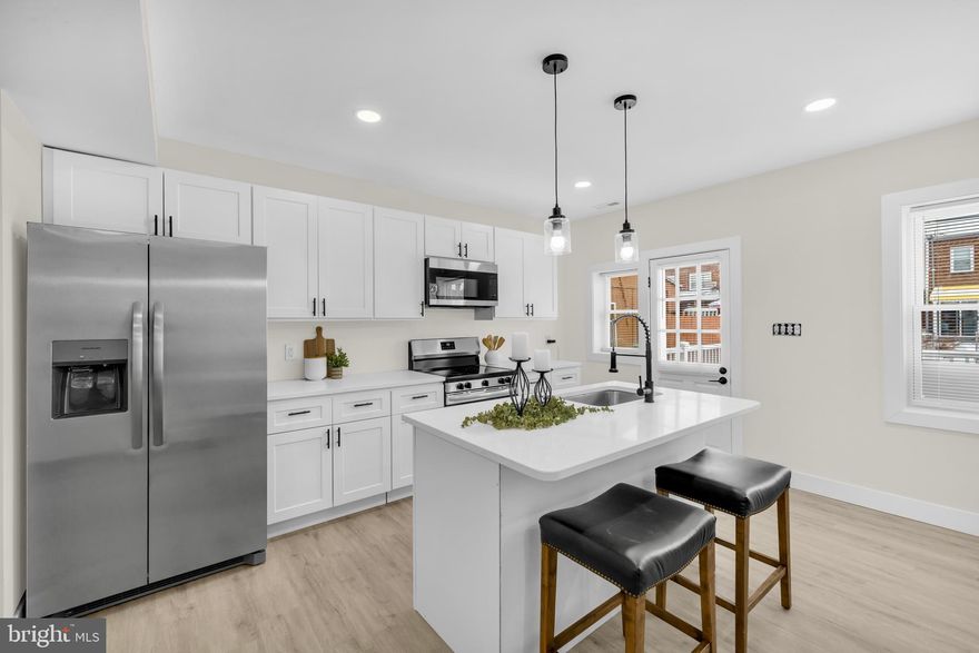 ***QUALIFIES FOR $15K GRANT TOWARDS CLOSING COSTS***

Welcome home to this stunning, completely renovated end-unit featuring 4 bedrooms, 2 full baths, and 1 half bath. The main level boasts gleaming hardwood floors and a bright open-concept layout perfect for modern living and entertaining. Enjoy a stylish kitchen with stainless steel appliances, a large island with seating options, and seamless flow into the separate dining area. A convenient powder room is also located on the main level.

The inviting living space is highlighted by a striking accent wall and a built-in fireplace, creating a warm and elegant focal point. Step outside to a spacious deck overlooking the backyard—ideal for relaxing or hosting gatherings. The home also offers a parking pad for added convenience.

The walkout basement provides excellent additional living space, perfect for entertaining, along with a bonus room featuring a closet that can be used as an office, guest room, or flex space.

Additional features include a covered front porch, backyard, and the privacy of an end-unit location. This move-in-ready home combines modern upgrades, functional design, and outdoor living—an absolute must-see!