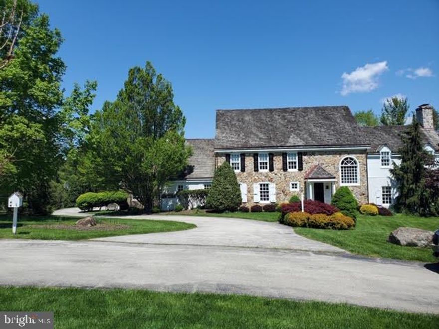Unbelievable Price for this Outstanding Belber Built Stone Colonial  Farmhouse  offers an abundance of upgrades on a prime lot  in the desirable Leopard Farms community.  Situated on 3 acres of picturesque land overlooking a beautiful pool, large rear lawn, open space and the woods, this impressive home features  over 5500 square feet of exceptional living space on first, second and third floor , 5-6 Bedrooms, 4 full baths and 2 Powder Rooms  and  and a finished lower level. A Fabulous highlight of this charming expansive family home is the  newer custom gourmet kitchen designed and completed  recently by Malvern Kitchen and Bath with an  over sized island and butler s pantry/ bar area  that opens to the breakfast room and family room.. The exterior features include Pennsylvania Farmhouse stone and siding facade, winding flagstone walkway leading to the impressive front door with covered porch and lush grounds with mature plantings. Columns support the cedar shake roof of the covered front porch leading to the solid wood front door flanked by curved plaster walls. The interior of this grand center hall colonial manor home offers classic brick flooring with impressive turned staircase with  impressive candelabra chandelier and palladium window , landing and, exquisite  custom mill work throughout.  The elegant step down living room features exquisite wide random width wood floors, a large picture window on the rear wall and a charming wood burning fireplace with wainscoting flanked by double bookcases on one side and a window on the other side. and two  front windows overlooking front grounds .From  the Center hall there is access to a Charming Study with rustic paneled  wall and cozy fireplace with a door to large screened porch.  The other side of the Center Hall leads to a private powder room, has access to the kitchen and goes  to  a large  formal dining room with similar wide plank random width wood  floors,  chair rai,l crown moulding and  adjoins the impressive kitchen  which opens  to the breakfast room and family room.  Large new chef s kitchen with over sized granite  island with 3 pendant  lights above is surrounded by gorgeous beaded inset kitchen cabinetry with glass display cabinets and upgraded appliances including 60  Wolf  commercial size range with griddle, paneled Sub-Zero refrigerator and Bosch dishwasher. Butler s Pantry/ Bar area  with two refrigerator built in drawers and  separate under the  counter wine refrigerator and   opens to large vaulted breakfast  room with a wall of casement windows, and opens to a charming  family room featuring  impressive beamed ceiling  and a Large walk in fireplace with  old world charm.  Convenient back stairs to second level, stairs to finished lower level, a large mudroom with laundry and a second powder room complete this level The second floor includes a luxurious master suite with large bedroom with center  fireplace with wood mantel and two builtin bookcases on the left, sumptuous master bathroom with his and her vanities,make up vanity,  walk-in his/her closets and a separate room has a large glass shower and soaking tub .  The second-floor hallway with open balcony  leads to 3 additional bedrooms. The  Two bedrooms on the rear of the house share a hall bath  The fourth bedroom on this level has its own private bath   Another  back staircase leads  to the finished third floor  which offers 2 bedroom or a bedroom and large sitting room  a full bathroom, cedar closet and some attic storage . Finished lower level/basement offers a large finished area for tv viewing and game area . The screened-in porch off back of the house features access to the rear patio, pool with hot tub and views of the bucolic setting. This spectacular home is convenient to the airport and center city , corporate centers,shopping and restaurants in  Wayne, Devon, Berwyn and Paoli and many area golf courses.