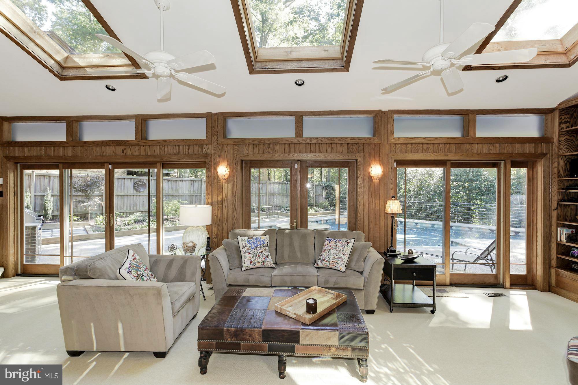 DRAMATIC soaring spaces & light filled rooms! Striking step down LR w/2 story ceilings, 17 skylights, large open DR, award winning table space kit, glass walled family room overlooking gorgeous pool. Impressive 1st floor master suite w/sitting room, FP, door to deck w/hot tub. Lower level features au pair suite or apartment incl. with separate entry, full kitchen/full bath. Backup offers welcome