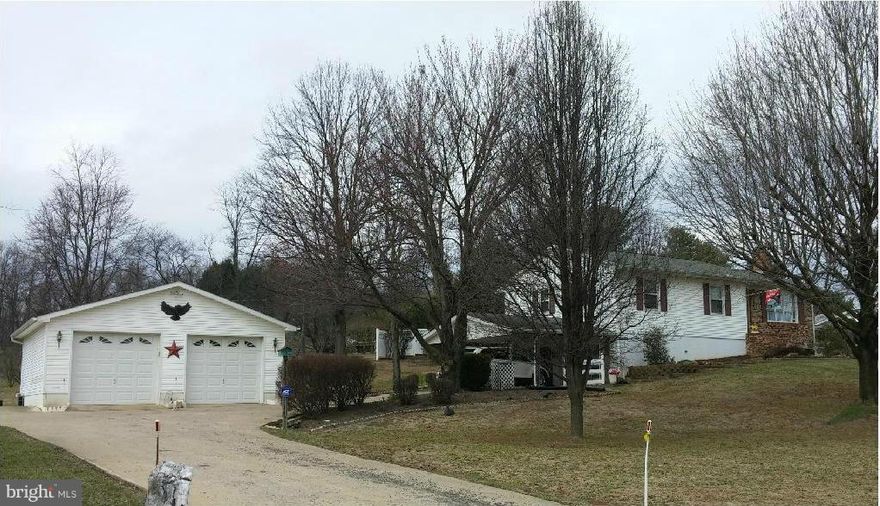 Truly great find...well-maintained immaculate rancher on landscaped large corner lot.  Three BRs, 1-1/2 baths on main level with lovely one BR apt. lwr level renting for $850.month, separate wash/dry (Owner pays electric and cable).  Well and septic. Huge enclosed sunroom off dining room leading to outdoor garden.  Attached double carport and detached 2-car garage.  $2,500. closing costs to buyer.