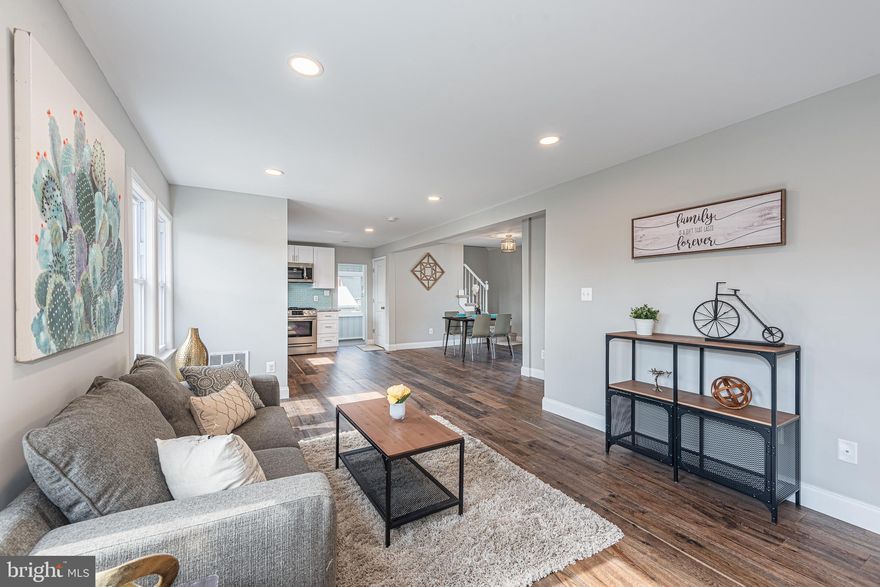 BEAUTIFULLY DESIGNED RENOVATION WITH OVER 2,000 SQ. FT. OF LIVING SPACE!  Features include an enclosed front porch with tons of natural light, an open floor plan with an inviting living room, gourmet kitchen with ss appliances & granite counters, a separate dining area, entry level bedroom with a full bath, upper level Primary bedroom suite with 2 closets & a full bath, a fully finished basement with a family room, bedroom, full bath, and ample storage space, an enclosed patio which overlooks the large rear yard, and both front and rear parking!  This one has it all!