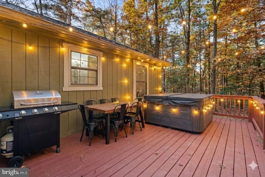Nestled in the serene community of Bryce Mountain, this charming cottage-style home offers a perfect blend of comfort and modern amenities, making it an ideal investment opportunity. Built in 2002 and recently renovated in 2023, this property boasts a pristine condition that is sure to attract discerning buyers. Step inside to discover a warm and inviting interior featuring three spacious bedrooms and two full bathrooms. The open-concept design seamlessly combines the dining and living areas, enhanced by beautiful wood floors and a cozy gas fireplace, perfect for those chilly evenings. The primary suite includes a luxurious bath, while upgraded countertops throughout add a touch of elegance. Ceiling fans and a well-placed entry-level bedroom ensure comfort and convenience for all. The kitchen is equipped with essential appliances, including a dishwasher, electric oven/range, and refrigerator, making meal preparation a breeze. The main floor laundry adds to the home's practicality, allowing for easy living. Outside, the property shines with its thoughtfully designed exterior features. Enjoy summer barbecues on the deck or relax in the hot tub under the stars. The expansive lot, measuring 0.29 acres, is beautifully landscaped and backs to trees, providing a tranquil retreat. Additional amenities include a BBQ grill, outdoor lighting, and a play area, making it perfect for gatherings or quiet evenings. Security is paramount, with a comprehensive system that includes smoke detectors, exterior cameras, and 24-hour monitoring, ensuring peace of mind for residents and guests alike. From an investment perspective, this property offers significant potential for rental income, especially given its desirable location and modern features. The association provides snow removal and road maintenance, enhancing the appeal for seasonal renters or long-term tenants. The proximity to stunning mountain views and wooded areas adds to the property's allure, making it a sought-after destination for nature lovers and outdoor enthusiasts. With its combination of comfort, modern amenities, and investment potential, this home in Bryce Mountain is not just a property; it's a place to create lasting memories. Don't miss the chance to make this inviting retreat your own or add it to your investment portfolio!