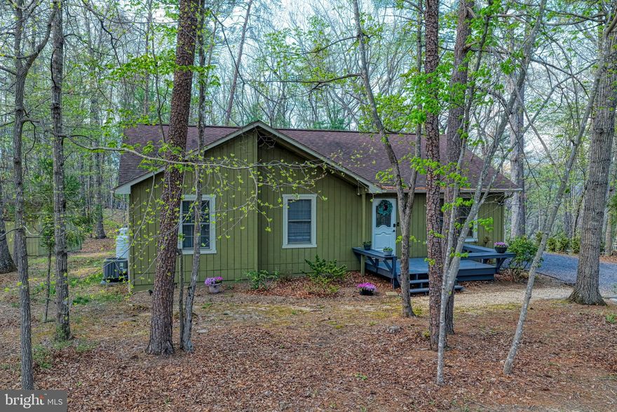 Nestled in the serene community of Bryce Mountain, this charming cottage-style home offers a perfect blend of comfort and modern amenities, making it an ideal investment opportunity. Built in 2002 and recently renovated in 2023, this property boasts a pristine condition that is sure to attract discerning buyers. Step inside to discover a warm and inviting interior featuring three spacious bedrooms and two full bathrooms. The open-concept design seamlessly combines the dining and living areas, enhanced by beautiful wood floors and a cozy gas fireplace, perfect for those chilly evenings. The primary suite includes a luxurious bath, while upgraded countertops throughout add a touch of elegance. Ceiling fans and a well-placed entry-level bedroom ensure comfort and convenience for all. The kitchen is equipped with essential appliances, including a dishwasher, electric oven/range, and refrigerator, making meal preparation a breeze. The main floor laundry adds to the home's practicality, allowing for easy living. Outside, the property shines with its thoughtfully designed exterior features. Enjoy summer barbecues on the deck or relax in the hot tub under the stars. The expansive lot, measuring 0.29 acres, is beautifully landscaped and backs to trees, providing a tranquil retreat. Additional amenities include a BBQ grill, outdoor lighting, and a play area, making it perfect for gatherings or quiet evenings. Security is paramount, with a comprehensive system that includes smoke detectors, exterior cameras, and 24-hour monitoring, ensuring peace of mind for residents and guests alike. From an investment perspective, this property offers significant potential for rental income, especially given its desirable location and modern features. The association provides snow removal and road maintenance, enhancing the appeal for seasonal renters or long-term tenants. The proximity to stunning mountain views and wooded areas adds to the property's allure, making it a sought-after destination for nature lovers and outdoor enthusiasts. With its combination of comfort, modern amenities, and investment potential, this home in Bryce Mountain is not just a property; it's a place to create lasting memories. Don't miss the chance to make this inviting retreat your own or add it to your investment portfolio!