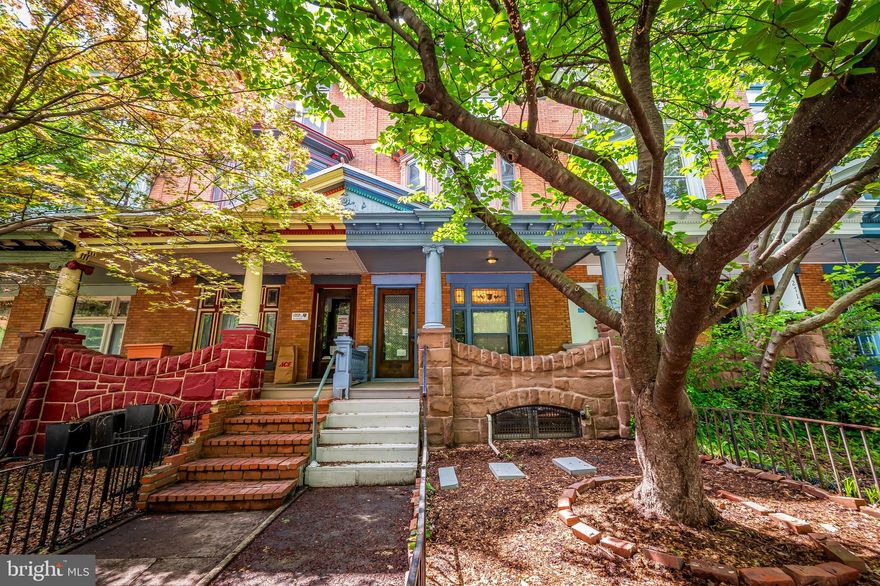 Charming 5BR/3.5BA Porchfront Rowhome in the Heart of Charles Village

Welcome to this beautifully maintained Charles Village gem—an expansive porchfront rowhome blending timeless architectural details with thoughtful modern updates. Step through the original vestibule into a spacious foyer/sitting room featuring stunning restored inlaid hardwood floors and elegant period charm throughout.

The main level offers an ideal balance of comfort and function. A custom open kitchen with an oversized pantry and adjacent full bath is conveniently located just off the rear parking pad, which fits multiple vehicles—perfect for easy unloading through the kitchen or basement entrance.

Original pocket doors lead from the large living room to the formal dining room, both showcasing exquisite stained glass windows, a built-in storage bench, and a beautifully preserved staircase.

Upstairs, the second level boasts three generously sized bedrooms and a full bath with a classic clawfoot tub. The front bedroom features a charming built-in bench, original mantle, pocket door, and lovely views of a mature double-blooming cherry tree that adds beauty and privacy. The rear bedroom includes a small private balcony with peaceful western exposure.

The third floor offers incredible flexibility—use it as a sunny bedroom suite with original mirrored closets and bright eastern light, a home office with skylight, or convert it into a full primary suite. A staging room leads to the rooftop deck, where you'll enjoy sweeping city views and serene relaxation.

The basement, while unfinished, includes a rec room, laundry area, half bath, and a second full bathroom (plumbed but sold as-is). It's ready for your vision and finishing touches.

All of this in a premier location—just blocks from Johns Hopkins University, the Baltimore Museum of Art, Waverly Farmers Market, and Penn Station. Located within the Charles Village Benefits District, this is city living at its best.