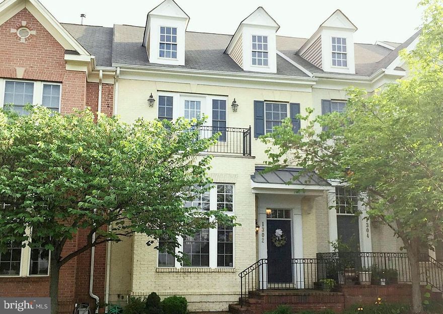 Exceptional! One of the largest model with 3.5 bath! High-end upgrades with solid hardwood flooring throughout. Large open KIT w/granite countertop & stainless appliances.  Dramatic double story living room. Separate Dining area. Master bedroom with 2 large walk-in closets, separate shower & soaking tub! High ceiling basement with a full bath. Spectacular views overlooking a park and enjoy the July 4th Firework right from the front windows!  Take a stroll through the park to the playgrounds and many sport counts. Amazing community amenities including  free shuttle to the Metro, two outdoor swimming pools, club house, fitness center, tennis court and much more.  Walk to Starbucks, grocery, banks, restaurants and shops!  Don't miss! Owners require good credit and sorry, absolutely no pet.