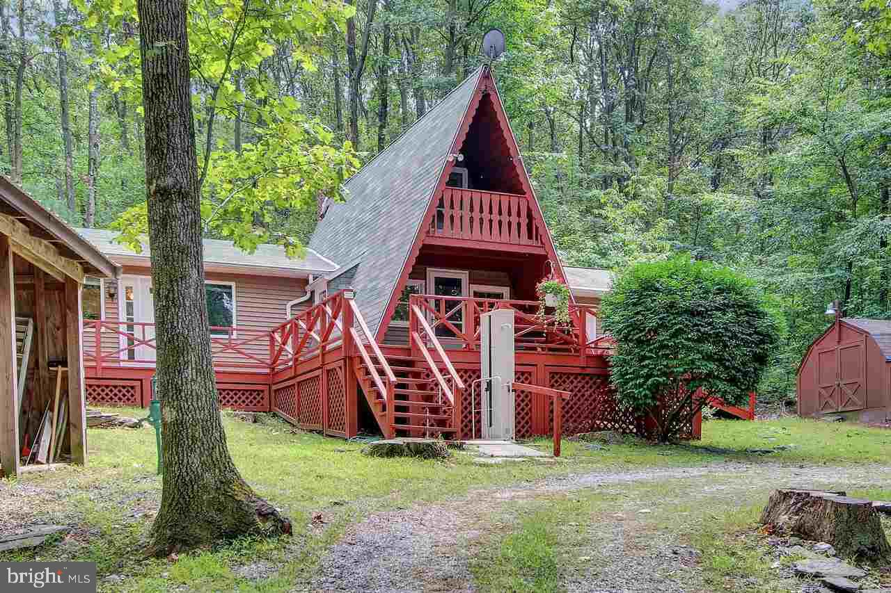 Spic & span 2 bedroom, 2 bath, 2.5 acre, two car carport mountain retreat used for year round living. Spacious master suite, 1st floor laundry, kitchen with woodstove insert, 2nd bedroom loft, newly stained deck, roofs cleaned 2016, block foundation with vapor barrier & dehumidifiers, 1 wood & 2 storage sheds, circular drive, ATS generator.