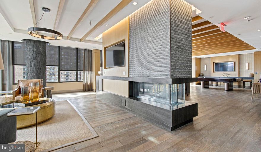 Nestled in the vibrant heart of Bethesda, Maryland, this luxury apartment complex offers an unparalleled living experience that combines modern convenience with sophisticated design. Designed to cater to the discerning tastes of urban dwellers, this property stands as a testament to luxury living, where every detail has been meticulously crafted to ensure the utmost in comfort and style.

*Exceptional Location*
Located in the sought-after Woodmont district, the apartment complex is perfectly positioned as a gateway to the best that Bethesda has to offer. Residents enjoy easy access to a plethora of amenities, including the Walter Reed National Military Medical Center, the NIH, and a variety of shopping, dining, and entertainment options. The prime location also offers convenient access to public transportation, making it easy to explore the wider metropolitan area.

*Architectural Elegance and Design*
The building's U-shaped design opens up to a beautifully landscaped courtyard, offering a seamless transition from the bustling city life to a tranquil oasis. The architecture is both richly textured and humanly scaled, creating an inviting streetscape that residents are proud to call home. A dramatic window wall façade and ground-level duplex units with front porches and planters further enhance the building's aesthetic appeal.

*Luxurious Amenities*
Residents of this apartment complex enjoy access to an array of exceptional amenities designed to enhance their lifestyle. The property boasts a large fitness center, fireside lounges, and a rooftop lounge equipped with bars, fireplaces, grilling areas, and two pools. Additionally, the convenience of having a 50,000 square foot grocery store within the building cannot be overstated. The property is also LEED Gold Certified, reflecting a commitment to environmental sustainability.

*Sophisticated Living Spaces*
The apartments themselves are a reflection of the luxury and sophistication that define the property. With a variety of floor plans, including studios, one to three-bedroom apartments, and townhomes, there is something to suit every preference. Each unit features designer finishes, stainless steel appliances, and spacious layouts that make coming home a pleasure.

*Community and Convenience*
The property is known for its friendly and helpful staff, ensuring that the needs of residents are met with professionalism and care. The well-maintained common areas and the sense of community fostered among residents make this complex more than just a place to live—it's a place to belong.

This luxury apartment complex in Bethesda, Maryland, offers an unmatched living experience for those seeking the best in urban living. With its prime location, architectural elegance, luxurious amenities, and sophisticated living spaces, it stands as a beacon of modern luxury and convenience. Realtors and renters looking for a property that combines the vibrancy of city life with the comfort of upscale living will find everything they desire and more at this premier apartment complex.

** Pricing and availability subject to change on a daily basis ** Photos are of model units ** Parking may be available for additional fee **