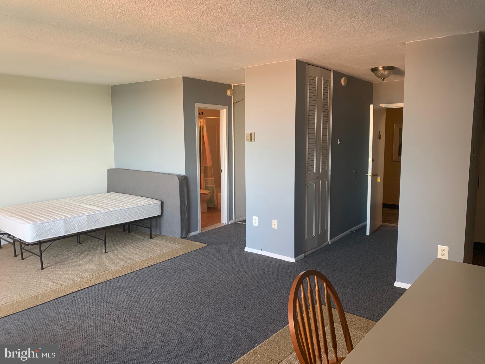 This charming unit is available for lease beginning October 11, 2025 and features updated kitchen and bath along with balcony with great views of Guilford Park. Newer carpet and freshly painted. Walking distance from JHU Homewood Campus. Pool, exercise room. Rent includes: water, gas, electricity, HOA, heating, and AC! Onsite front desk support. The building has a roof-top swimming pool, and ground level community room with big-screen TV and full service kitchen that residents can rent for private parties and gatherings. On-site laundry is available. On-site, garage parking is available as well for a fee.
You can easily jump on the free Shuttle Buses that stop just outside the door to site see Charm city. Check out the south view of Charles Village and the Johns Hopkins’ Campus. The Charles Village Shopping Center is just a block away with Barnes and Noble, Starbucks, Chipotle, and other name retailers. Other features include Zip Car rentals just across the street.