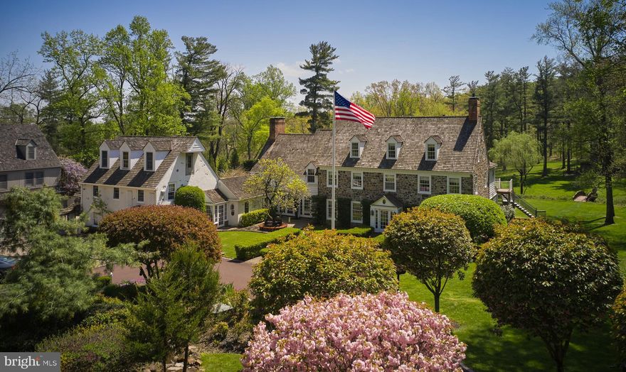 A long gated, tree lined driveway leads one into this cloistered family compound with a custom reproduction manor house, a  4 bedroom carriage house with a gated private motor court, and breathtaking gardens. Espalier fruit trees guide one through hidden stone paths to a potting house and a fenced orchard. A conservatory opens out to expansive terraces, leading to the heated in ground pool, hot tub, and stone deck, bordered with lush perennials and manicured privet. Beyond the pool is a pond with a fountain surrounded by verdant landscape and a foot bridge to the hen house. This magnificent property is set on 5 secluded acres in the heart of Upper Makefield Township. The main house features an elegantly appointed foyer with sweeping circular staircase. To the right, a formal living room with fireplace and sitting room, to the left, a formal dining room. An expansive library with fireplace provides access to the terrace. Beyond you’ll discover the commercially appointed gourmet kitchen, a breakfast room with walk-in fireplace overlooking the pool, a glass conservatory opening to expansive terraces on one side and secret gardens on the other.  The main house features 6 bedrooms, 5 are en-suites with fireplaces, one has a hall bathroom. There is also a powder room and laundry room on the main level. On the lower level one will discover an additional bedroom, full bath, a full bar, game room with pool table, workout room and storage rooms. The carriage house has 4 en suite guest rooms with outdoor living spaces, and a large conference room with hall bath. This property has 5 oversized garages, lush grounds, full irrigation system supplying the hanging planters flanking the driveway and motor court, and security system. This is a rare opportunity to become the next steward of such a significant and iconic property.