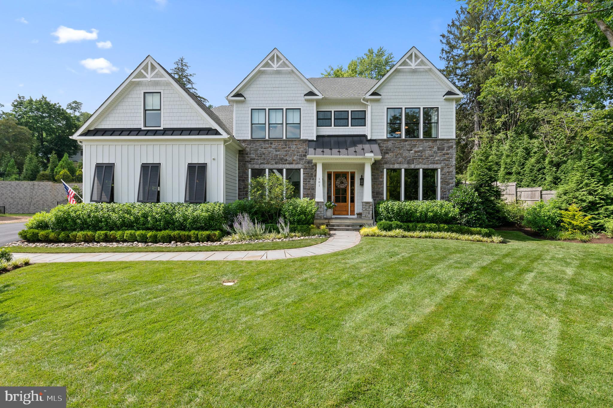 Crafted by the esteemed Rockwell Custom, this exceptional home is nestled within a cul-de-sac community of 13 residences. Incorporating exquisite design, functional spaces and nearly every upgrade available, it's a testament to quality construction and attention to detail, promising an epitome of luxury living. The Roosevelt design exemplifies a perfect blend of elegance and practicality, making it ideal for both social gatherings and relaxed living.
Stepping into the two-story foyer, you're welcomed by the warm, inviting living room. A spacious home office, complete with built-in cabinetry, is an ideal environment for work or study, paired with a strategically positioned powder room for guests. A dining room is a ideal space for dinner parties, served by a convenient wet bar and fridge. The dining room transitions seamlessly into a gourmet kitchen, finished with sleek quartz countertops, white cabinetry and top-quality appliances, including a La Cornue range, a Subzero fridge, and a Bosch dishwasher. The breakfast room offers a comfortable atmosphere for casual dining. A gas fireplace in the adjacent family room, along with double French doors leading to the rear patio, blends indoor and outdoor living. An additional French door in the kitchen enhances outdoor accessibility.
The home's emphasis on convenience and functionality is demonstrated by a walk-in pantry, furnished with a second oven and refrigerator drawers.
Next to the kitchen, a mudroom, featuring a herringbone floor, built-in workstation, shelving, and tasteful wainscoting, leads to the two-car attached garage. Hardwood flooring throughout the main level imbue the home with elegance and refinement.
On the second floor, another home office space is graced with a wall of bookshelves. The primary bedroom, complimented with ceiling beams and elegant built-ins, leads to a luxurious full bath with a tub, a walk-in shower, and a double sink vanity.
The home includes an ensuite bedroom with abundant closet space and two additional bedrooms connected by a Jack and Jill bath. An upstairs laundry room, complete with a barn door entry, washer, dryer, and unique tile flooring, offers ample folding space. A secondary staircase adds convenience and architectural intrigue.
The walkout lower level is a haven for relaxation and entertainment. The den, with its brick accent wall and linear fireplace, exudes charm. A full wet bar, an exercise room with a rubber floor and mirrored wall, and a wine room enhance the living experience.
Additional noteworthy features include millwork and moldings in many rooms, Bermuda shutters in the study and kitchen, lighted glass display cabinets in the kitchen, a professionally landscaped exterior with a paver terrace and espalier apple trees, decorative ceiling treatment in the foyer and a tech-friendly Sonos & Lutron system. The home also includes an irrigation system with drip lines and a Belgian block driveway apron.
The peaceful location makes it easy to forget how convenient close you are to award-winning schools, dining, shopping and all major transportation routes.