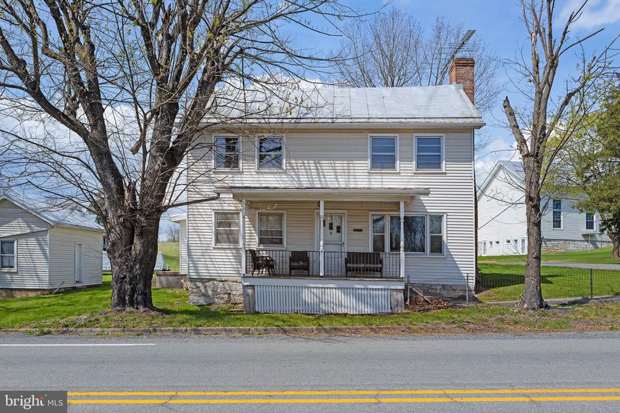 Step into timeless charm with this spacious 5 bedroom 1.5 bath farmhouse, full of character and potential.  This classic home offers a warm and inviting layout featuring a galley kitchen, dining room, and a cozy living room with a propane fireplace, perfect for relaxing evenings.  Enjoy your morning coffee or unwind in the enclosed sunroom, which conveniently includes the laundry area for added functionality.  Situated on a desirable corner lot, this unique property includes three separate parcels, offering extra space or future possibilities.  Outside you'll find a two story detached garage complete with a man cave, ideal for hobbies, entertaining, or additional storage.  This property is perfect for those seeking country charm with room to grow.  Don't miss this rare opportunity!