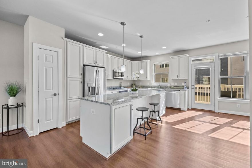 A stunning luxury townhome in the sought-after Travilah community.  The original owner acquired New Construction, which has been meticulously maintained. This former Model Home came pre-loaded with premium builder upgrades, including upgraded cabinetry, countertops, and enhanced trim work.  Spanning over 2,500 square feet of modern, open concept living space, this home offers 4 bedrooms, 3 full baths, and 2 half baths.  Modern wide-plank LVP floors flow throughout the main level, while oversized windows fill the interior with abundant natural light.  The stunning white gourmet kitchen features stainless steel appliances, a large farmhouse sink, granite countertops, and crisp white shaker cabinetry that seamlessly connects to the spacious living room, dining area, and private balcony.  A rare and standout feature is the Private Elevator providing effortless access to every floor, along with a Private Rooftop Terrace offering expansive views and a dedicated pet relief area added for convenience. The upper level also includes a versatile loft space ideal for a home office, lounge, or fitness, which opens to a private guest suite with its own ensuite bath, offering comfort and privacy for visitors. Recent improvements include updated bathroom fixtures & hardware, new mirrors, enhanced LED & recessed lighting, modern ceiling fans with remotes in each room, new energy efficient front-loading washer and dryer, and refreshed paint throughout. An attached two-car garage, 2 extra driveway spaces, and additional off-street parking provide plenty of room for vehicles and guests, while ample storage throughout adds to the home’s everyday convenience.  Equipped with a dual-zone HVAC system, allowing customized climate control on multiple levels.  Ideally located in the desirable Travilah area near shopping, dining, and major commuter routes, and just minutes to the Inverness Recreation Club with its extensive amenities. This home offers the perfect combination of modern luxury, thoughtful upgrades, and low-maintenance living. 1k lender credit to the buyer's closing costs for using our preferred lender.