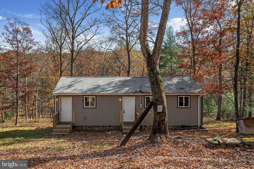 Quiet peaceful living with wildlife all around! Enjoy this super cute, well-maintained, MOVE-IN-READY ranch home on 2 wooded acres in beautiful Augusta, WV. This 2-Bedroom, 1 Bath home boasts cathedral ceiling with lovely, exposed beam in the living room, a convenient kitchen layout with pantry storage area, a wonderful deck with plenty of space to enjoy the sound of the trickling stream on the back of the property. The fall foliage provides beauty all around! Space has been maximized in this cozy home that has been tastefully decorated. Includes 2 sheds plus it has a tall crawlspace for added storage. New well pump, pressure tank, and water heater have recently been replaced. Clean and ready for its new owner(s)! Don't let the size fool you - this is a great space and would make a fabulous AirBNB for the investor or a year-round home! There are 4-wheeler trails on the property and when there is minimal rain, the creek bed makes a great spot to ride. Reasonable HOA fees at only $100/year.