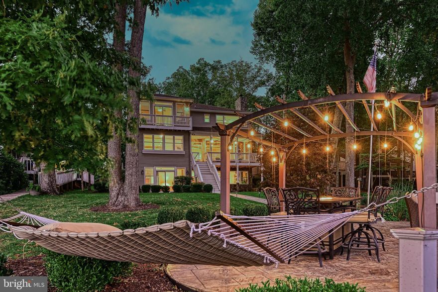 Welcome to your dream lakefront retreat!  This stunning 6-bedroom, 5.5-bathroom custom-built lakeside sanctuary offers the perfect blend of elegance, comfort, and waterfront living – located just 90 minutes from Washington DC and within 60 minutes from Richmond, Charlottesville, and Warrenton, Virginia.  Perfectly situated for gorgeous lake views in one of the premier sections of Lake of the Woods, this 5602 square foot luxury home combines timeless elegance with modern comforts, offering both grandeur and serenity in a private, picturesque setting. As you step inside the main level, you’re greeted with open-concept living spaces, rich hardwood floors, and expansive windows in the family room framing breathtaking views of the water. Thoughtfully designed for both everyday living and unforgettable entertaining, this custom-crafted home features a gourmet kitchen that is a chef’s delight, with a professional-grade gas range, granite countertops, high-end stainless steel appliances, and a large island that flows seamlessly into the dining and living areas – ideal for hosting family holidays, summer get-togethers, or festive celebrations. The gas fireplace creates the perfect ambiance for evenings relaxing with the family or close friends. The main level also boasts a guest-suite with an adjoining bathroom and an in-home office. The spacious primary suite on the upper level is a true oasis with large windows showcasing fantastic lake views from its expansive windows and private balcony. The spa-like master bathroom features a luxurious steam shower, a jacuzzi soaking tub, dual vanities, and a large adjoining closet. The upper-level also contains a game-room and three additional bedrooms, including a Jack-and-Jill bathroom, and a beautifully-appointed guest room offering stunning lake views and comfort for special weekend guests. On the lower level, this waterfront retreat showcases a fully-equipped in-law suite, with a kitchenette, expansive dining and family room, an oversized master bedroom, adjoining bathroom with a shower and dual vanities, and a laundry room and closet. The lower level provides a private living space with its own entrance, perfect for extended visits of family or guests, or even a rentable apartment. This incredible lakeside home possesses not only an attached three-car garage, large enough to house your vehicles and favorite rafts and other water toys, but also a detached single-car garage for additional storage, or for use as a workshop or for building the perfect man-cave. Outdoor living is at its finest with multiple spaces to relax and take in the beauty of Lake of the Woods, starting with a private covered porch on the main level, ideal for both morning coffee and evening entertaining. Expansive front and backyards, complete with an irrigation system, provide ample space for recreation and relaxation. The newer lakeside patio and dock are fully appointed for entertaining, providing a beautifully-landscaped stage for swimming and sunning during the day, and then stargazing by the fire in the evenings. The dock features space for three boats and includes a high-capacity boat lift. This lakeside retreat is fully-equipped and ready for boating, fishing, or simply soaking up the serenity of lakeside living. Furnishings and the two boats are negotiable, offering a very unique turnkey opportunity. This gated community offers resort-style amenities including beaches, parks, clubhouse dining, tennis and pickleball courts, an equestrian center, a state-of-the-art pool, fitness complex, and an 18-hole championship golf course. Nestled in one of the most tranquil sections, this 2009 lakehouse provides stunning views and a peaceful setting. From evenings by the stone fireplace to days on the water, it captures the best of lakefront living—perfect for year-round enjoyment or a vacation retreat, blending comfort, style, and natural beauty.