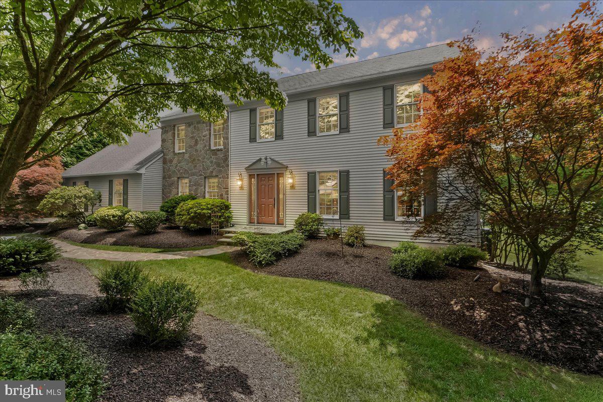 Welcome to this exquisite colonial retreat located at 14 Pond View Lane, a stunning 4-bedroom, 2.5-bathroom center-hall colonial that exudes elegance and modern sophistication. Nestled on a cul-de-sac in a quiet and private location in East Goshen Township, this exceptional residence has been meticulously maintained and thoughtfully upgraded by its original owners, offering an unparalleled blend of style, comfort, and craftsmanship. From the moment you arrive, you’ll be captivated by the pristine landscaping, graceful uplighting, and inviting stone walkway, all leading to a brand-new Provia fiberglass front entry door adorned with sidelights and an acorn pediment overhead. Inside, the welcoming center hall features a Waterford light fixture, gleaming hardwood floors, flanked by a spacious living room with low pile stylish carpeting and a formal dining room adorned with raised panel wainscoting and hardwood flooring for a touch of classic elegance. At the heart of the home, the stunning eat-in kitchen boasts rich wood cabinetry, high-end stainless-steel appliances, custom wet-bed tile flooring, a tile backsplash, and granite-counter tops and featured island. Adjacent to the kitchen, a sun-drenched sunroom with Velux skylights with solar-powered remote-controlled shades provides breathtaking views of the private backyard and deck access through another new Provia entry door. The step-down family room is a true showstopper, featuring site-finished oak hardwood floors, a stone wood-burning fireplace, and a new Provia Triple Panel Swinging Patio Door leading to a large Azek deck with white vinyl railings and an electric retractable canvas awning. The first floor is completed by a convenient laundry room and an updated powder room with Kohler fixtures, along with access to the attached two-car garage. Upstairs, the primary suite is a luxurious retreat with site-finished oak hardwood flooring, a true walk-in closet, and a breathtaking custom master bath. This spa-like ensuite features custom tile flooring, a Bain Ultra Hydro-Thermo Massage tub with air jets, a custom vanity with built-in cabinetry, granite countertops and a separate spa shower with frameless glass doors and Moen fixtures, all enhanced by a privacy pocket door. The fully renovated hall bath is equally impressive, boasting a custom vanity, stylish lighting, a cast-iron tub with sliding glass shower doors, and built-in cabinetry for additional storage. Three generously sized guest bedrooms complete the second level. The beautifully finished walk-out basement adds even more living space, featuring low pile carpeting and two separate storage areas. This home is loaded with high-end upgrades, including custom millwork with crown molding throughout, a new 17 SEER HVAC system, three new Provia fiberglass entry doors, an Azek deck, updated bathrooms, a refreshed kitchen, a new 5” gutter system, a re-stuccoed chimney, and upgraded carpeting with deluxe padding on the stairs, second-floor hallway, and three bedrooms. A rare opportunity to own a move-in ready home of this caliber in Malvern, this property offers a perfect blend of modern updates and timeless charm. Don’t miss your chance to make 14 Pond View Lane your forever home!
