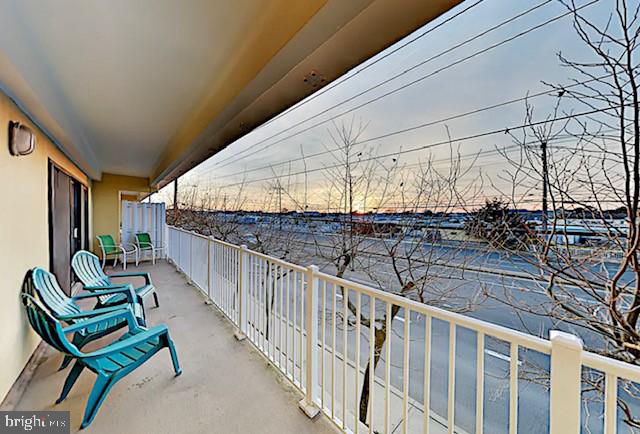 This beautiful beach block condo displays a wide open and airy floor plan that features 3 sizeable bedrooms and two full baths just steps from the warm Ocean City sand. A gorgeous kitchen boasts granite counters, breakfast bar, graphite stainless appliances, and overlooks the dining area. The spacious dining room is embellished with a decorative pendant light and offers plenty of space for gathering with family and friends over a meal. A lovely living room opens off the dining room and welcomes peaceful daylight through a 3-pane glass slider. Open the glass sliding door to step out onto the front view balcony where you can soak in the relaxing coastal air. Primary suite hosts personal access to the front balcony and an attached bath with tiled shower. Two additional sizeable bedrooms are great for hosting guests. This desirable unit is conveniently located on the first level and provides a ground level storage locker perfect for storing all of your beach essentials. Walk-out your door to enjoy the beach or bay within steps. This North Ocean City location is close to Fenwick Island and Bethany Beach while still in close proximity to Seacrets Jamaica USA, Jolly Roger Amusement Park, Outlets, Fish Tales, Fager's Island, and more, offering a vast variety of shopping, dining and entertainment options. Make this your next beach getaway or great investment with rental history of 28-30k annually.