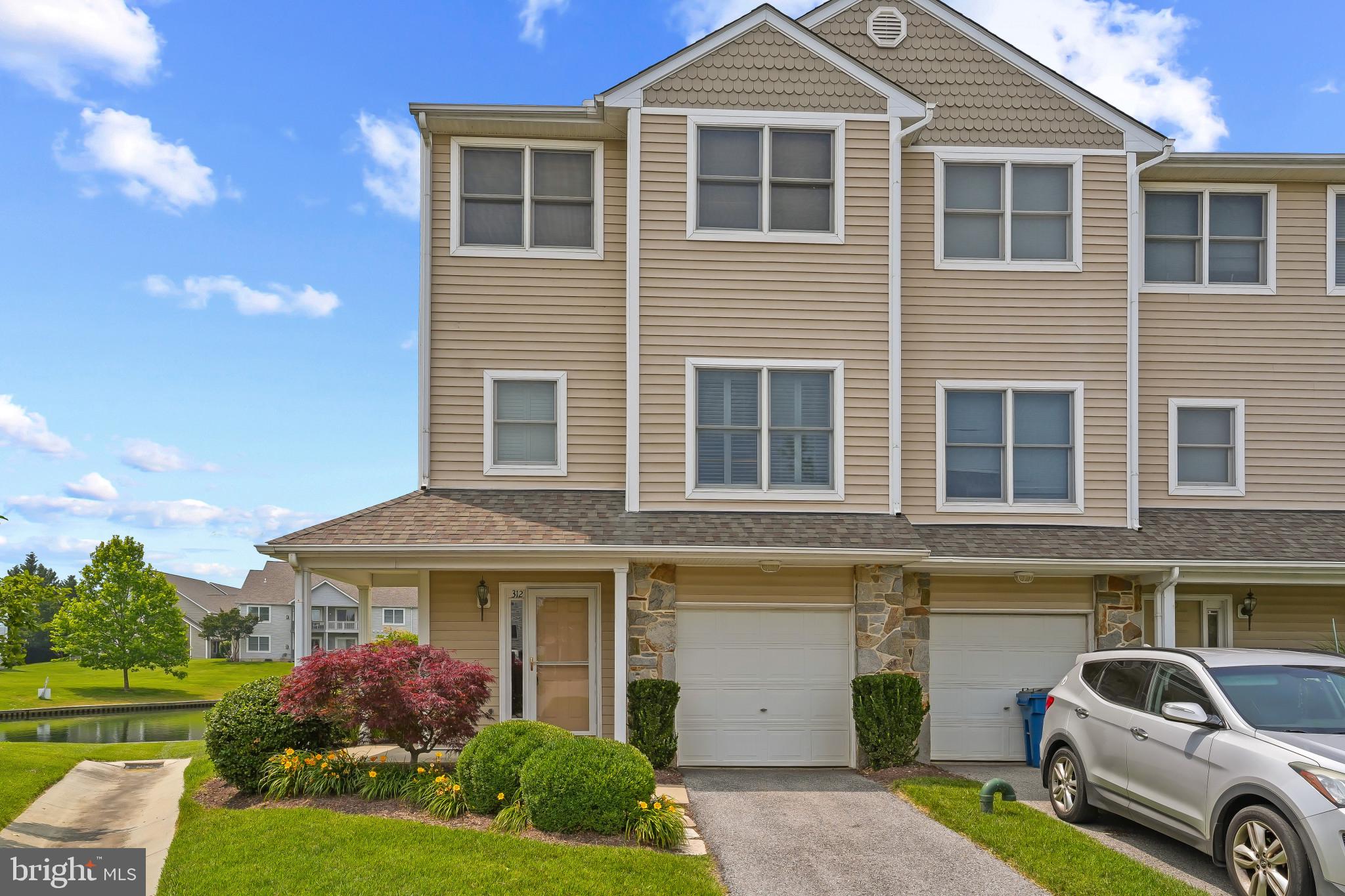 You do not want to miss this opportunity to enjoy island living in this maintenance free, WATER VIEW-End UNIT! Come enjoy island living in the Bayside Community. Offering POND views from every window in this sought after end unit home complete with beautiful landscaping. Relax on your spacious deck overlooking the pond complete with 2 fountains or invite family and friends to enjoy a cookout on your ground level patio. Enter the ground level from the street, including a garage complete with storage shelves and door opener. Ground-level family room, or 4th bedroom, with sliding door access to patio and rear open space, also a half bath and laundry room. Main level has an open concept living, featuring hardwood flooring throughout a spacious combination living room/dining room with fireplace, crown moldings and 9ft. ceilings. An eat in kitchen with upgraded cabinets, appliances and granite countertops. Plantation shutters adorn the kitchen and tiled powder room windows. Living room has sliding doors opening to a large deck! Step out to a wonderful view of the pond and green open space, enjoy the moment. The upper level includes a spacious master suite with vaulted ceiling, walk-in closet and full bath with skylight. Two additional good-sized bedrooms with vaulted ceilings and another full bath complete this level. The exterior maintenance is taken care of by the Community Association along with the exterior shrubbery and mulch. Complete maintenance free living. The Bayside Community offers so many amenities including an outdoor pool, tennis courts and a recently renovated clubhouse complete with workout room and party room. Bayside is conveniently located near marinas, restaurants and the Cross Island Trail, perfect for walking, jogging or biking. This is the perfect place to enjoy life. Hurry!