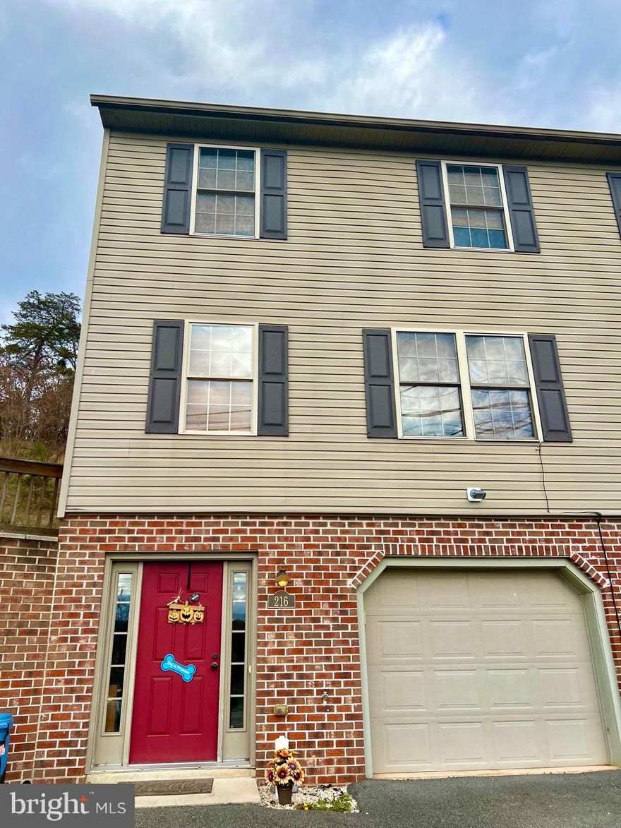 Enjoy scenic mountain views from this well-maintained 3 story 2007 duplex/townhome in beautiful Hancock, Maryland with over 1500 square feet of finished living space! Conveniently located just minutes from I-70 and I-68, and approximately 20 miles to I-81, this home is commuter-friendly for those looking for a home or rental in this relaxing, rural town. You can walk or ride your bike just down the street from your doorstep to the C&O Canal National Park, Western Maryland Rail Trail, and Potomac River or enjoy local antique shops and restaurants in downtown Hancock and nearby Berkeley Springs or drive up the road to Rocky Gap State Park, Casino, and Golf Course.  As you enter the foyer from the paved driveway you'll appreciate the durable ceramic tile floor. From here, you can access a large storage closet, a workshop/exercise/laundry/utility area where you have easy access to the Heat Pump (replaced August, 2021) and water heater, and the oversized 1 car garage. Proceed up the wide staircase to the open main level with a living/dining room combination and kitchen with pass-through breakfast bar. Watch the sunrise over the mountains through the large double-pane windows in the living room or enjoy dinner on the back patio outside the kitchen via sliding glass door. Relax and enjoy the views from the side yard. A half-bath and large pantry closet can be found just off the kitchen. Continue to the upper floor to find a roomy master suite with private views of the backyard and a walk-in closet and full bathroom. As you walk down the hallway, you’ll notice the rounded corners on the textured walls with custom paint and five inch base trim, which is found throughout the home. Access to the well-insulated attic via pull-down stairs is found in the hallway along with a second full bathroom, linen closet, and two bedrooms with windows facing east with mountain views. This quality-built home is one of the few homes this new in the town of Hancock and would make an excellent primary or secondary home or investment property.