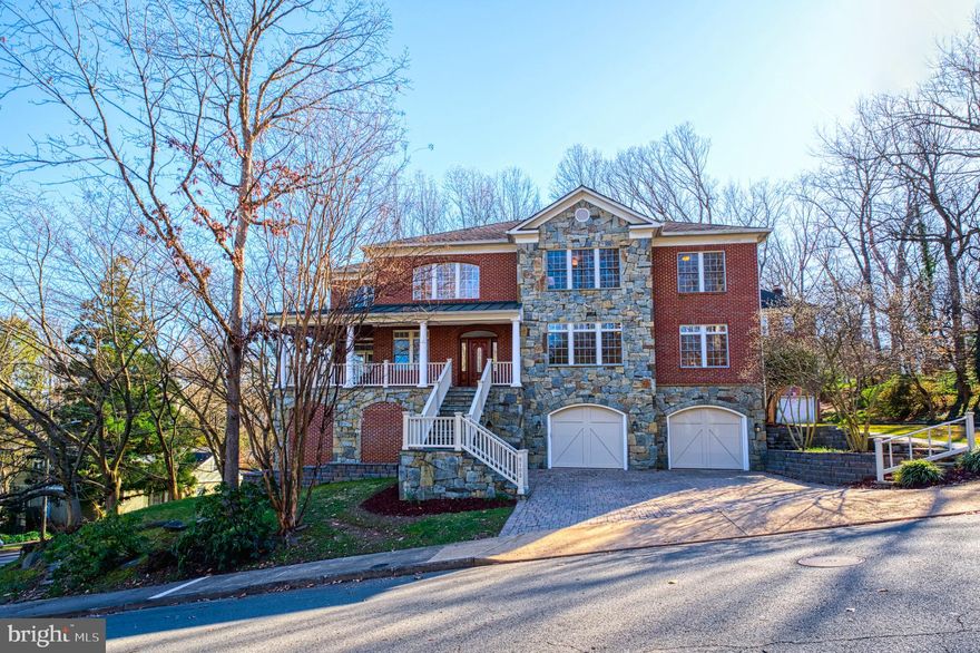 OPEN HOUSE SUN 1-4.  This gorgeous brick home is literally bathed with natural light streaming in through expansive windows in every room.  Enter the home to find a perfect combination of open flow and traditional rooms, as well as cozy nooks on each level.  The entire home has been freshly painted a warm white and features high ceilings, solid-core doors, hardwood floors, updated light fixtures, and substantial crown molding and trim throughout.  The house lives large yet comfy, with 3 fully finished floors and views of gorgeous landscaping and open space from every level.   Owners have recently upgraded the kitchen and bathrooms with gorgeous materials and finishes so that these spaces are stunning.  On the main level, the kitchen features a large center island and all stainless steel appliances:  a Viking cooktop, brand new 4-door french door Bosch refrigerator, 2 new dishwashers, new ovens (single convection wall oven with air fry & 2nd speed oven), new warming drawer, and a new Zephyr beverage center. The kitchen joins to a very spacious family room, the focal point of which is the floor-to-ceiling stone mantel surrounding the wood-burning fireplace.  There is a casual breakfast nook off the kitchen and a more formal dining room that is perfect for large dinner parties and holiday gatherings.  From the family room you can open the door to a spacious backyard wrap-around deck.  And for even more opportunity to enjoy the natural light and outdoor views, spend some time in the enclosed sunroom off the family room.  At the front of the main level are the living room and the dedicated main level office.  ++  Upstairs are four bedrooms, each one spacious.  The en-suite primary bedroom with tray ceiling and two walk-in closets also features an adjoining cozy sitting area perfect for enjoying a nice afternoon read.   The primary bathroom has been recently remodeled and features a luxurious soaking tub, a standing steam shower, two separate vanities, and a private toilet.   The second bedroom is also en-suite, and bedrooms 3 and 4 share a hall bathroom.  The laundry room is located in the upstairs hallway.  ++  The walk-out finished Lower Level has a large recreation room, another fireplace with stone mantel, and an attached exercise room with brand new carpet.  Here is also the 5th bedroom, perfect for au-pair, guests, or the independent teen.  There are plenty of storage areas, including a large mudroom.  The Lower Level enjoys abundant natural light and opens to a large terrace. ++ The two car attached garage is big enough for any vehicles, and houses three large storage rooms.  There is additional parking for two cars on the paver driveway.   ++  Perhaps the most lovely and unique aspect of this home is the variety of fantastic outdoor living areas accessible from each level to enjoy the surrounding nature with trees in bloom each season, including magnificent cherry trees.  The outdoor spaces are large enough to entertain on each level of the home.  The covered terrace off the lower level with flagstone pavers can be used on rainy days, while the decks off the main level are the perfect place to relax and enjoy every season of changing colors.   ++  This home exudes comfort and calm in a highly-desired close-in a North Arlington setting.  Homes rarely come available in this special enclave of Woodland Acres, which is walkable to Discovery Elementary, Williamsburg MS, and Yorktown HS.  From this home you can take advantage of the school's open fields and playgrounds, or visit the nearby neighborhood favorite Lee-Harrison Shopping Center with local restaurants, grocery stores, and other shops.  Or head into McLean for some additional shopping and dining options.  The bus stop at Old Dominion offers an easy and practical way to use public transit to get around the County or into DC.