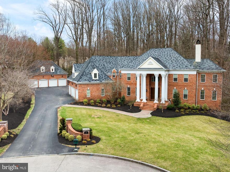 What if your getaway place was home? (TM) Experience life in the heart of the Main Line, where
you have convenient rail access to Center City and a high‐speed train to NYC just 5 minutes
away. The drive to Philadelphia International Airport is only 30 minutes. This property is located
in the award‐winning Radnor School District, with access to prestigious independent schools
and esteemed local universities. It also offers easy access to pharmaceutical, medical, and
financial centers.
Bryn Mawr is centrally located, providing excellent options for dining, exercising, local clubs,
sports facilities, and entertainment.
Nestled on 2 private acres—feeling more like 4 acres thanks to an additional 2 acres of open
space next door—this elegant Georgian Colonial home sits at the end of a cul‐de‐sac,
surrounded by beautifully styled residences. It boasts numerous unexpected features that
enhance its sophistication.
Upon entering this custom Dulgerian home, you are greeted by soaring columns and a sweeping
staircase that frames the grand foyer. The foyer offers a glimpse into the formal rooms. To the
left, the elegant dining room can accommodate twenty guests, while across the hall, the
exquisite living room captivates with its limestone‐carved fireplace. Just beyond the living room,
a warm and bright sunroom filled with greenery awaits.
At the heart of the home, an open floor plan connects all the main rooms. A great room, with a
wall of windows bringing in the natural landscape and a welcoming wood‐burning fireplace,
flows seamlessly into the chef's kitchen. This modern kitchen features light cabinetry,
professional‐grade stainless appliances, island seating, a butler's pantry, a walk‐in pantry, a wet
bar, and a breakfast room, making it the perfect space for entertaining.
A thoughtfully designed library, discreetly located behind the great room, offers a fireplace and
handsome cherry built‐in cabinetry, providing a tranquil workplace with picturesque wooded
views.
On the upper floor, the main suite serves as a wonderful retreat. It features a spacious bedroom
with a coffered ceiling, a fireplace, and plantation shutters. An adjacent sitting room boasts
spectacular views and is ideal for use as a gym or a second office. The spa‐like bathroom
includes a double shower, a large bathtub, an expansive vanity with double sinks, and
impressive cabinetry. Additionally, there are two walk‐in closets with built‐ins. On the other side
of the upper floor are two lovely bedrooms that share a Jack and Jill bathroom with double
sinks. Across the hall is an en‐suite bedroom with a private bathroom that has a shower and
vanity with double sinks. A tremendous in‐law or au‐pair suite with a generous private bath,
walk‐in closet, second closet, and a grand sitting area.
A spacious laundry room, conveniently located on this floor, provides access to the attic.

The lower level of the home serves as a walkout, extending across the entire floor plate and
featuring beautiful views of the woods and stream. It includes a large recreation room finished
with wainscotting, providing ample space for play and relaxation. Additionally, there is a wine
room (which could also serve as a safe room), a full bathroom, and a spacious storage area.
For car enthusiasts, this home is a dream come true, featuring four attached garage spaces.
There is also a detached two‐story garage that offers an additional four garage bays, along with
a finished room above and a powder room.