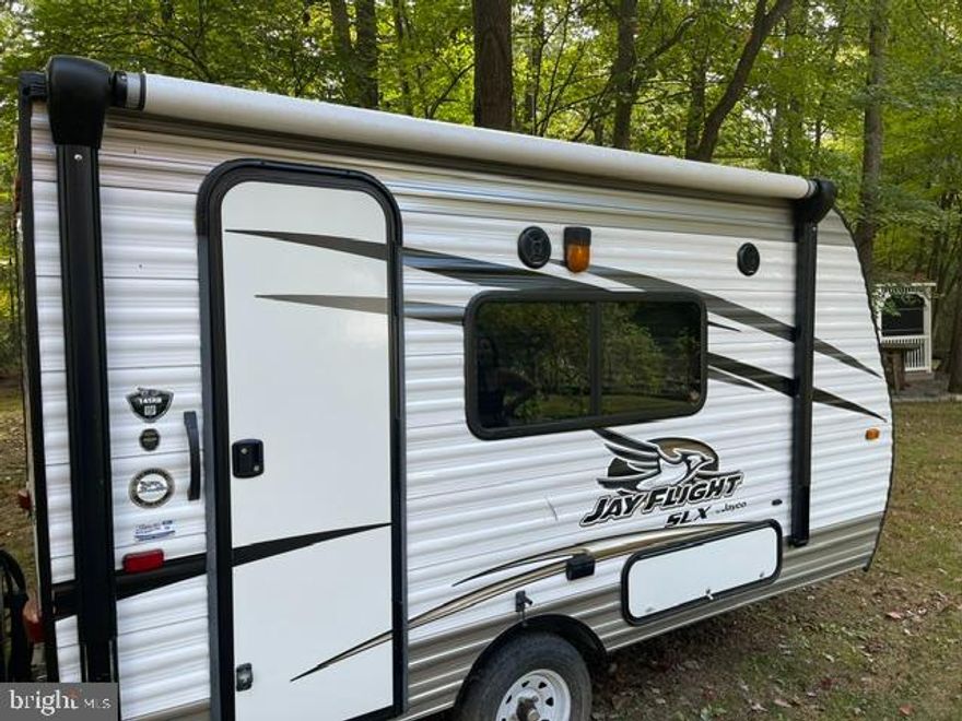 CAMPING SEASON IS ALMOST HERE!!! Nice level lot with a 2016 Jayco Jay Flight SLX RV tucked away in Riverbend RV Park with a GREAT WATER VIEW!!!  This lot is ready for YOU!   Features include water and electric hookups, shed, paved driveway, fire pit and Potomac River access for boating, fishing & swimming.  ** LOT BACKS TO TREES FOR ADDED PRIVACY **   Yearly membership to Riverbend Park includes water, sewer/pump out services, electric, trash and access to the park amenities and activities such as pools, putt putt, basketball court, tennis court, holiday fireworks for July 4th, car show, carnival, restaurant, playground, ball field and much more. Riverbend RV Park is located close to shopping, I81 & The C&O Canal for hiking & biking. Own this getaway in as little as 3 weeks. Call today before it's gone! **Gated community-pass required for entry. **Riverbend sales are SOLD "AS IS", CASH only and seasonal.** (Direct TV and Frontier Internet available with service install/hookup).  Call today for details on making this your summer getaway!!