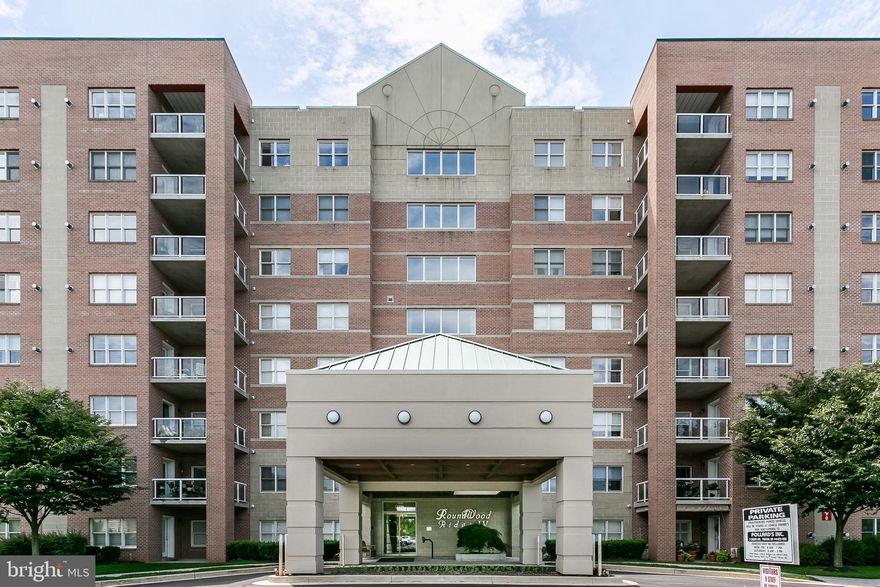 You have been waiting for this Roundwood condo to become available - here it is !!!  An end of group that is updated and has been meticulously maintained.  Light streams in from three sides - and highlights all this home has to offer.  The updated kitchen with stainless steel appliances opens to a lovely den and deck.  The living room with gas fireplace is complemented by the dining room with custom coffer ceilings.  The master bedroom is awash in natural light and boasts a large walk-in closet with built-ins and a fabulous master bathroom.   The second bedroom and bathroom provide ample space for guests.  Hardwood floors, tons of closet space and a dedicated parking garage space complete this picture perfect package.  This is a gem!!!