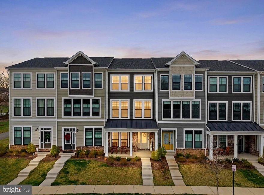 Move-in ready and built in 2023, this stunning 4-bedroom, 3.5-bath townhome with a 1-car garage offers over 2,200 square feet of beautifully finished living space across three levels. Wide-plank LVP flooring spans the lower and main levels, while a charming covered front porch, rare for a townhome, provides the perfect spot to relax. The open-concept main level is designed for modern living, featuring a light-filled living room, spacious dining area, and a dream kitchen complete with quartz countertops, a stylish tile backsplash, 42” shaker-style cabinetry, stainless steel appliances, and a large center island with bar seating. A glass door leads to a spacious deck overlooking tree-lined common ground, creating a seamless indoor-outdoor entertaining experience. Upstairs, the light-filled primary suite offers a walk-in closet and a luxurious en-suite bath with a quartz-topped dual vanity and an oversized frameless glass shower. Two additional bedrooms share a well-appointed hall bath, and the convenient bedroom-level laundry adds everyday ease. The lower level features a versatile fourth bedroom or home office, a stylish full bath, and access to the oversized garage with extra storage. Located in Heritage at Marshall, this community blends small-town charm with modern convenience. Enjoy being within walking distance to downtown Marshall’s shops, restaurants, cafés, bakery, and boutiques. Commuters will appreciate easy access to I-66, Route 55, and Route 17, while outdoor enthusiasts can explore nearby parks and nature preserves. Community amenities include a clubhouse, pool, tot lot, and walking trails, with HOA services covering lawn care, snow removal, and trash and recycling for added convenience.