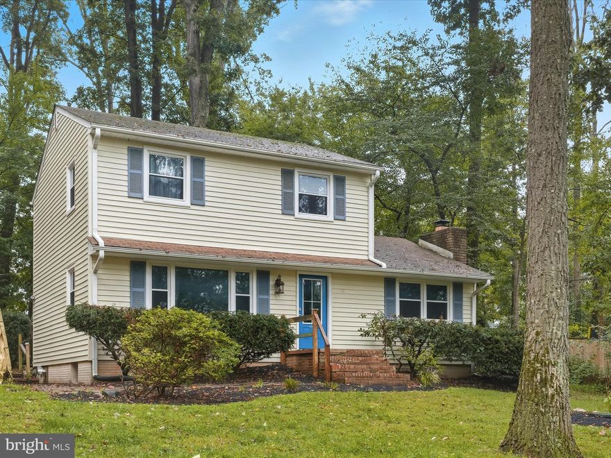 This charming three bedroom, one-and-a-half-bathroom home is perfectly situated on a 0.63-acre wooded lot, offering both privacy and a serene connection to nature. A long driveway and beautifully maintained landscaping create a welcoming first impression. Inside, a bright foyer leads through French doors into a sunlit living room, adorned with crown molding and built-ins. The dining area, accented with elegant chair railing, flows seamlessly into a kitchen with ample counter space and direct access to a spacious rear deck. Perfect for entertaining, the deck features a relaxing hot tub and overlooks a large, fully fenced backyard, which also includes a shed with electricity. A cozy family room provides a warm retreat, highlighted by a wood stove set against a charming brick wall. The main level is completed by a convenient half bathroom. Upstairs, all three bedrooms feature new carpet and share a full bathroom with a tub-shower combination. The lower level offers generous storage, coal stove and laundry. Recent updates include new ceiling fans, fresh paint, new carpet and flooring, a water heater replaced just one year ago, new landscaping, a concrete-covered carport, and a UV water filtration system, making this home move-in ready and thoughtfully maintained.