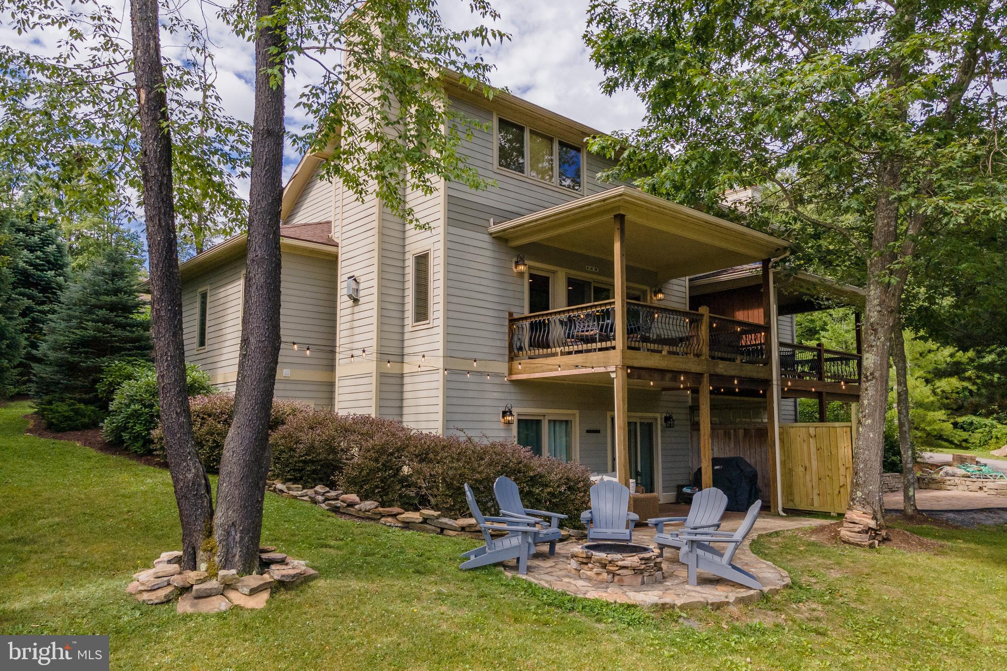 Overlooking Deep Creek Lake, this modern townhome delivers luxury, comfort, and unbeatable convenience. Located in Timberlake Village, the 5-bedroom, 4.5-bath retreat is minutes from top restaurants, marinas, state parks, and Wisp Resort. The main level was recently reimagined with contemporary lighting and timber accents, a modern kitchen featuring granite counters, stainless appliances, and a new fridge and dishwasher. The entry-level primary suite adds ease, while two ensuites upstairs provide space for guests. The walkout basement is fully finished with two more bedrooms, a Jack & Jill bath, and a second living area with a pool table. Outside offers two levels of covered decking, and an adjoining patio with a built-in fire pit. The stacked stone fireplace brings warmth in winter, while the attached garage offers storage and protection from the elements. An established rental, “On Lake Time” is sold turn-key and fully furnished—perfect as a personal escape or vacation rental property. Call today for details!