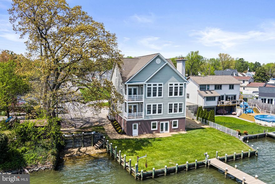 Welcome Home. Open House Scheduled This Saturday 9/21/24, 12-2pm. Nestled along the shimmering shoreline, this expansive and custom waterfront home is a stunning blend of modern elegance and coastal charm. The exterior showcases a contemporary design with clean lines, large windows, and a soft color palette that harmonizes with the natural surroundings. As you step inside, you are greeted by an open concept living space flooded with natural light. Floor-to-ceiling windows frame breathtaking views of the water, allowing sunlight to dance across the elegantly designed interiors. The spacious living room features high ceilings and affords comfortable furnishings, perfect for relaxing or entertaining guests. A stylish fireplace serves as a focal point, adding warmth to the space.  The gourmet kitchen is a chef's dream, equipped with high-end appliances, sleek countertops, and a large island with seating. Adjacent to the kitchen, a dining area offers a perfect spot for family gatherings, with glass doors that open to a lovely balcony overlooking the water, seamlessly blending indoor and outdoor living.
The home boasts multiple balconies, each offering unique perspectives of the waterfront. The main balcony is perfect for al fresco dining or enjoying morning coffee while watching the sunrise over the horizon. Another private balcony off the owner's suite serves as a tranquil retreat, complete with a cozy seating area ideal for unwinding with a book.  The owner's suite is a luxurious oasis, featuring a spacious layout, a walk-in closet, and an en-suite bathroom with a spa-like atmosphere, complete with double vanity and a walk-in shower, and a fireplace. Additional bedrooms are thoughtfully designed with large windows and ample storage, making them perfect for family or guests.  For outdoor enthusiasts, the property includes a private pier that extends into the water, providing direct access for boating, fishing, or simply soaking up the sun. Surrounding the home, beautifully lush yard can easily be updated with a firepit for cozy evenings watching boats go by under the stars.  This stylish waterfront home is not just a residence; it's a sanctuary that embodies the essence of coastal living, with every detail carefully curated to provide comfort, luxury, and a connection to the stunning natural surroundings.